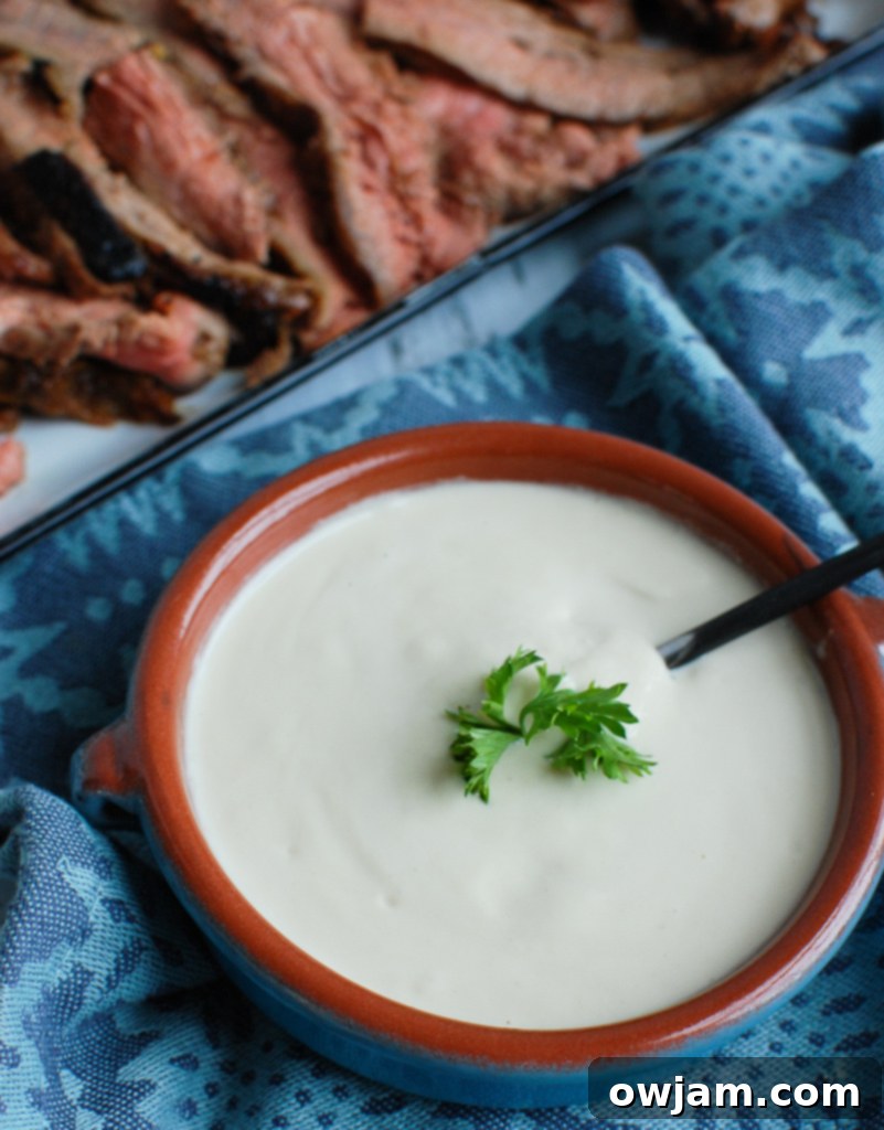 Creamy Tahini Sauce in a glass jar, ready to be drizzled over Mediterranean dishes like falafel waffles.