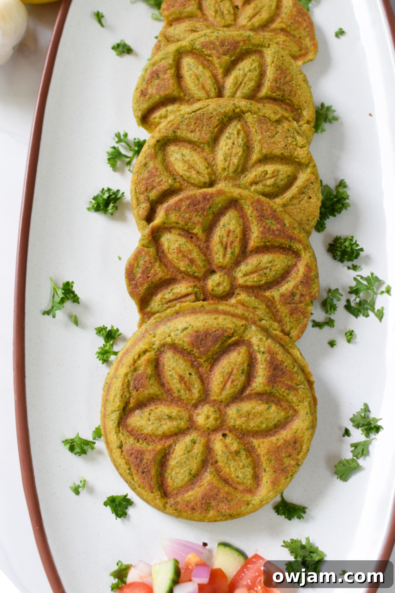 A beautifully arranged platter of golden-brown Falafel Waffles, garnished with fresh herbs and ready to be served, emphasizing a delicious and healthy meal.
