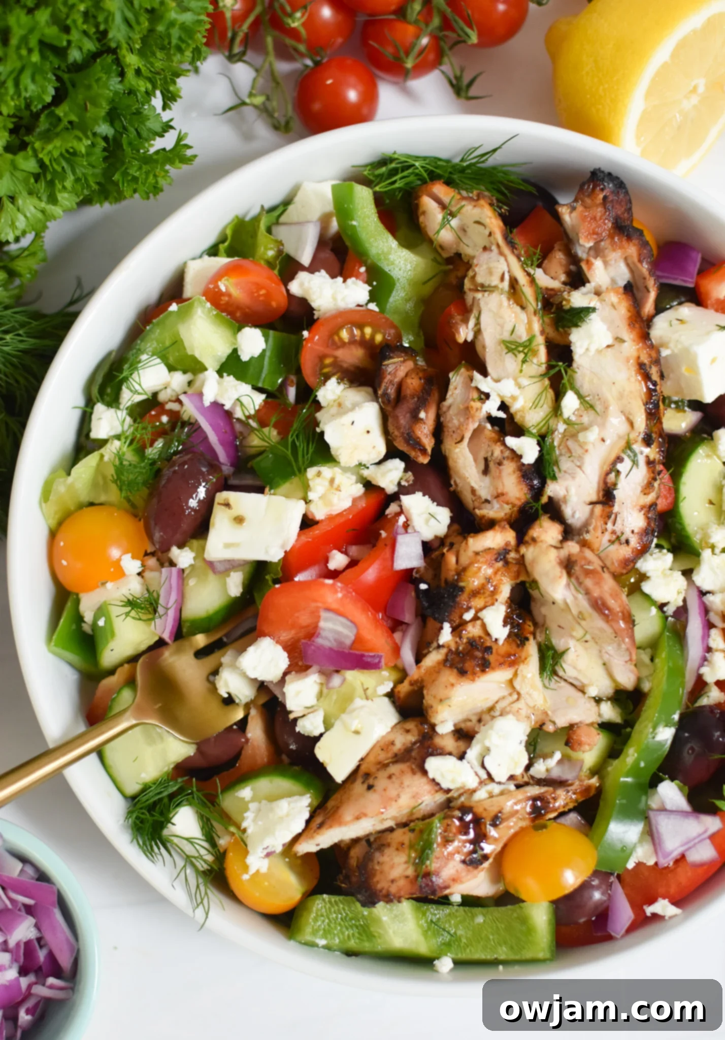 Sun-Kissed Grilled Chicken Greek Salad 2 A vibrant Grilled Chicken Greek Salad served in a white bowl, showcasing fresh ingredients.