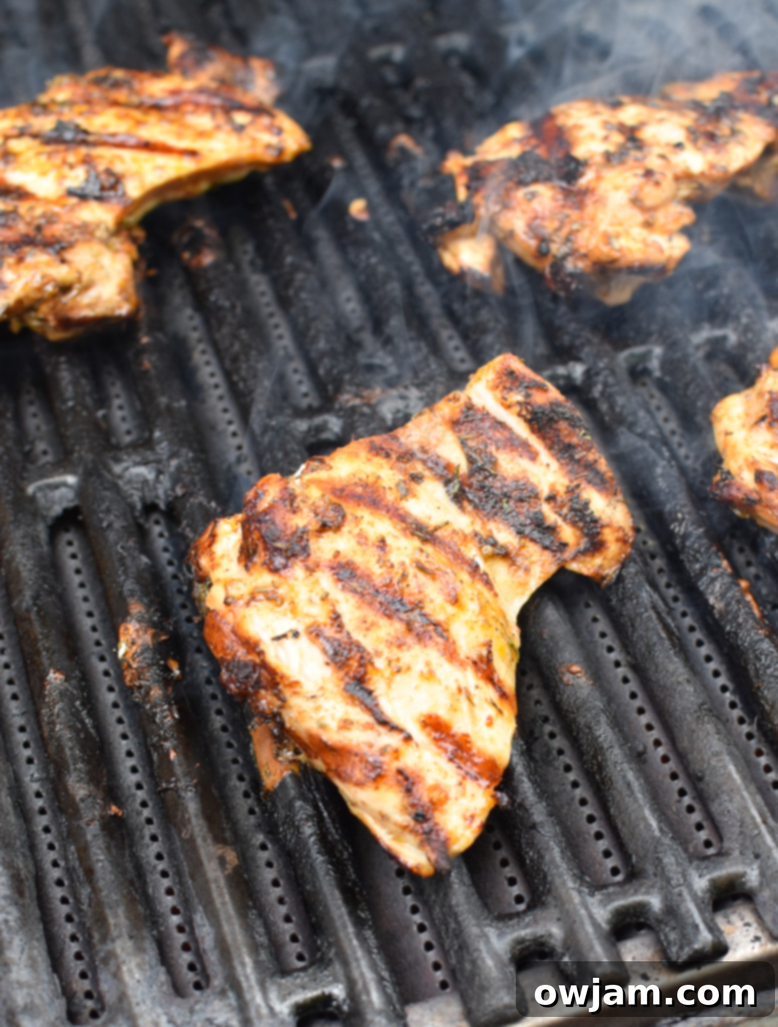 Sun-Kissed Grilled Chicken Greek Salad 7 Greek marinated chicken thighs grilling on a hot barbecue.