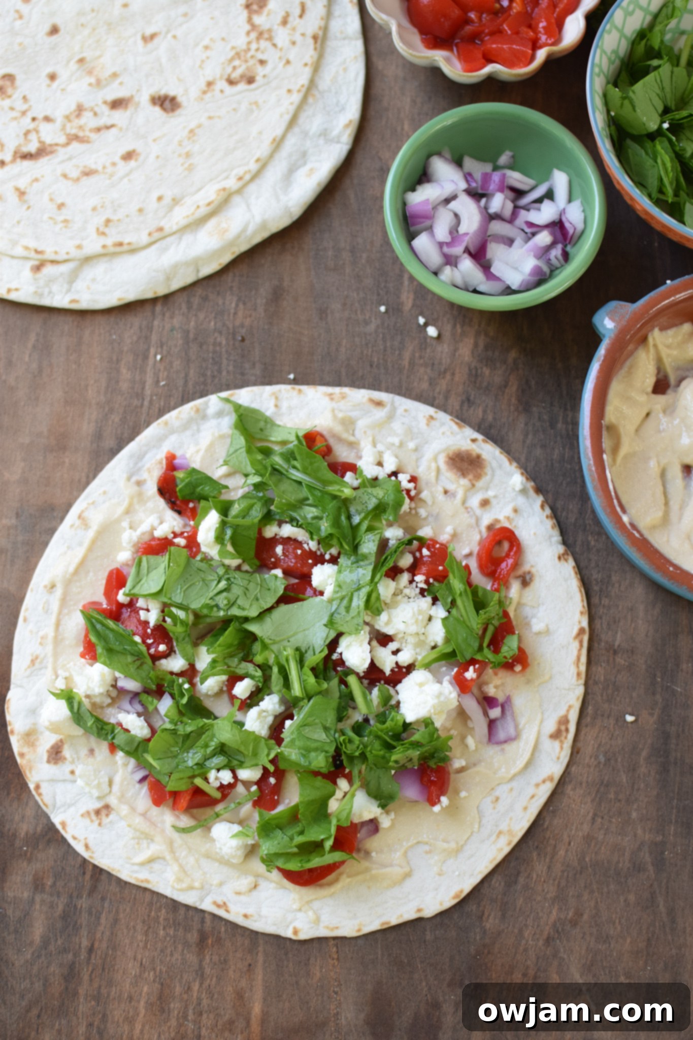 Savory Mediterranean Spirals 6 A tortilla generously filled with colorful Mediterranean ingredients like hummus, feta, roasted red peppers, and arugula.