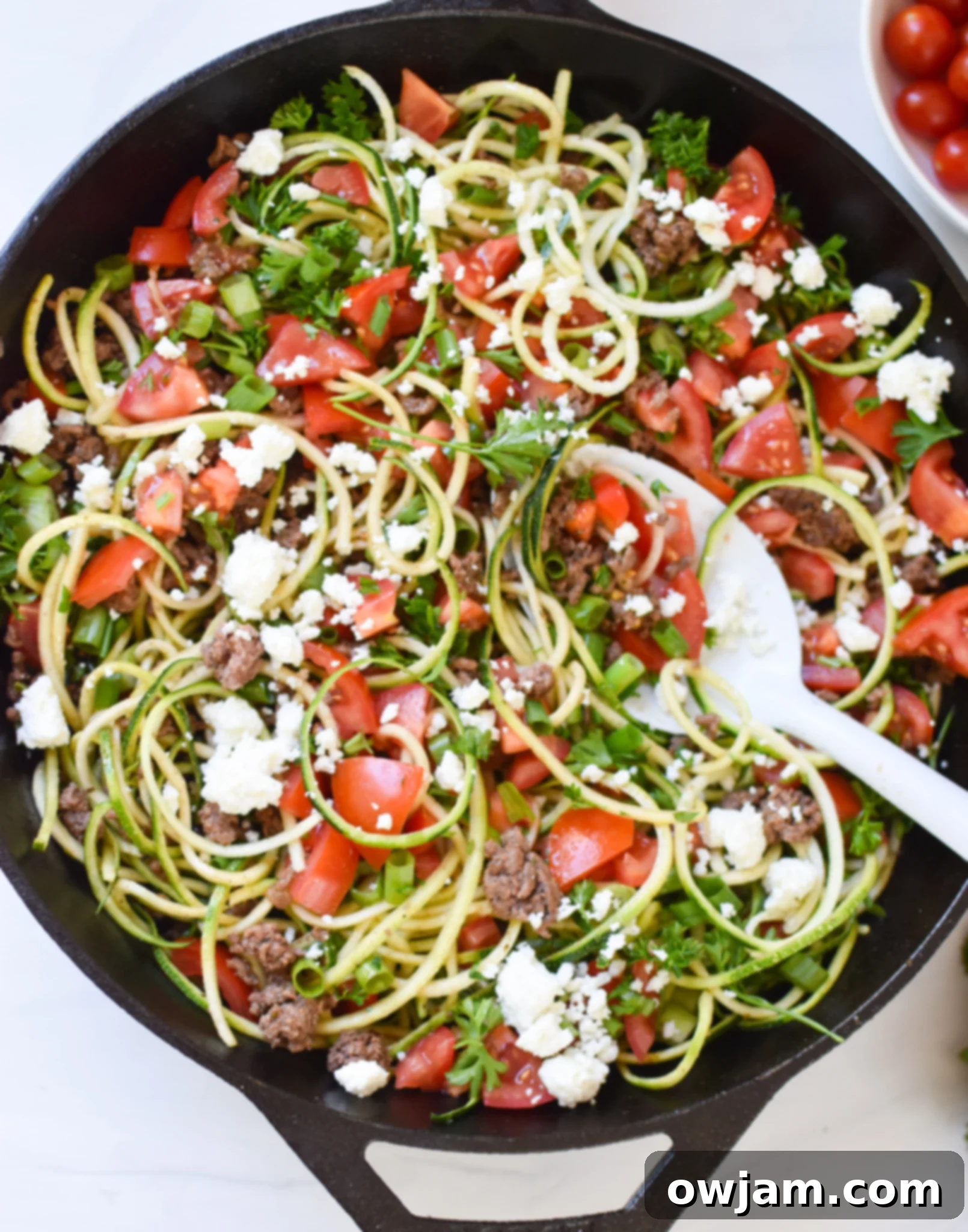 Vibrant Mediterranean Ground Beef Zucchini Skillet topped with feta cheese and fresh herbs.