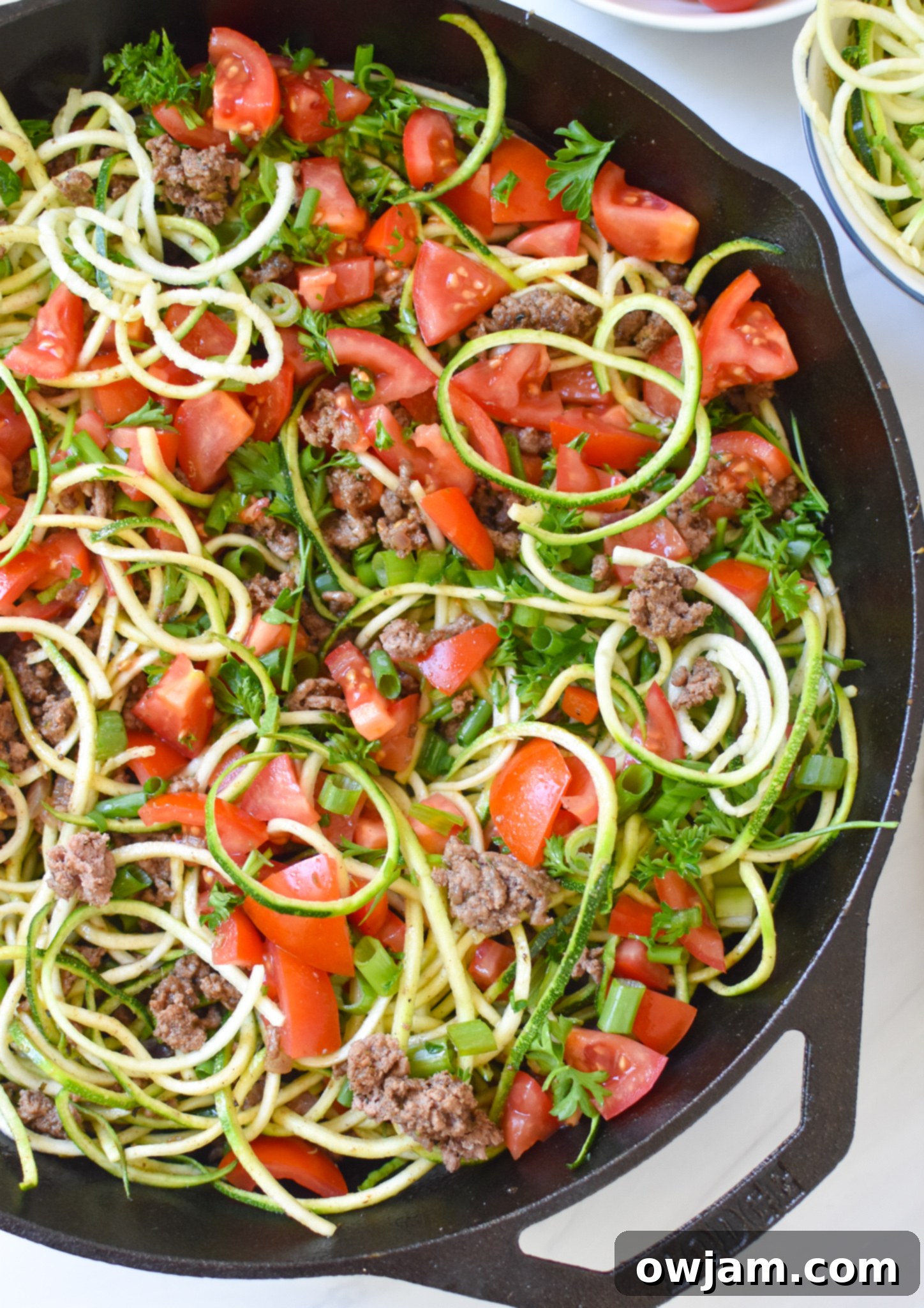 Mediterranean Ground Beef Zucchini Skillet in a cast iron pan, ready to be served.