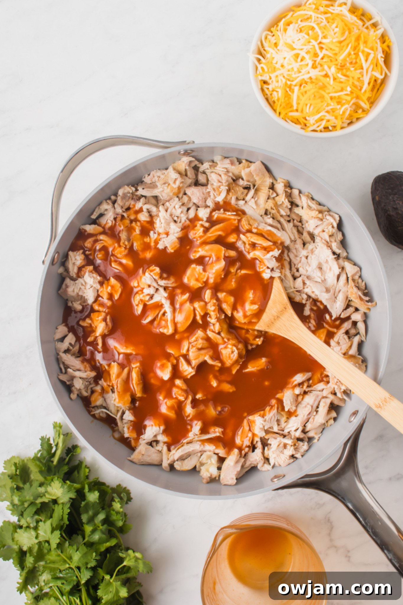 Irresistible Chicken Enchilada Sliders 6 Shredded chicken and enchilada sauce simmering with sautéed onions.