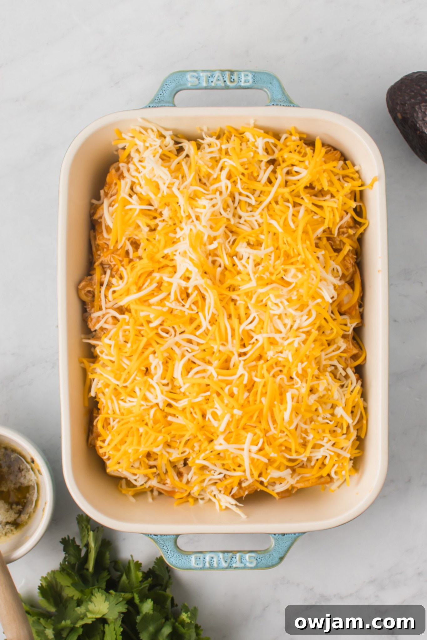Irresistible Chicken Enchilada Sliders 9 Shredded cheese generously sprinkled over the chicken enchilada mixture.