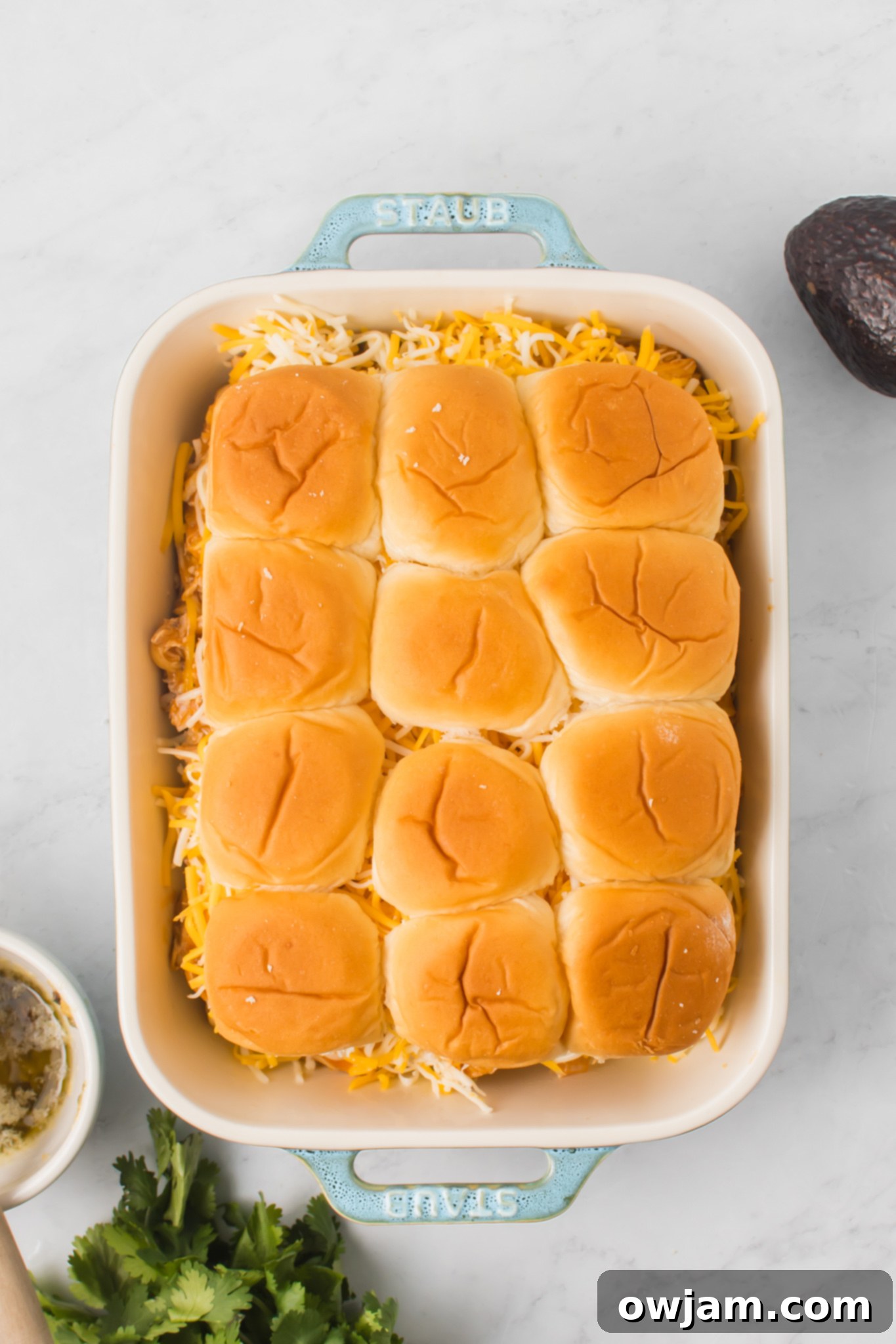 Irresistible Chicken Enchilada Sliders 10 The top halves of the slider buns placed over the cheese and chicken filling.