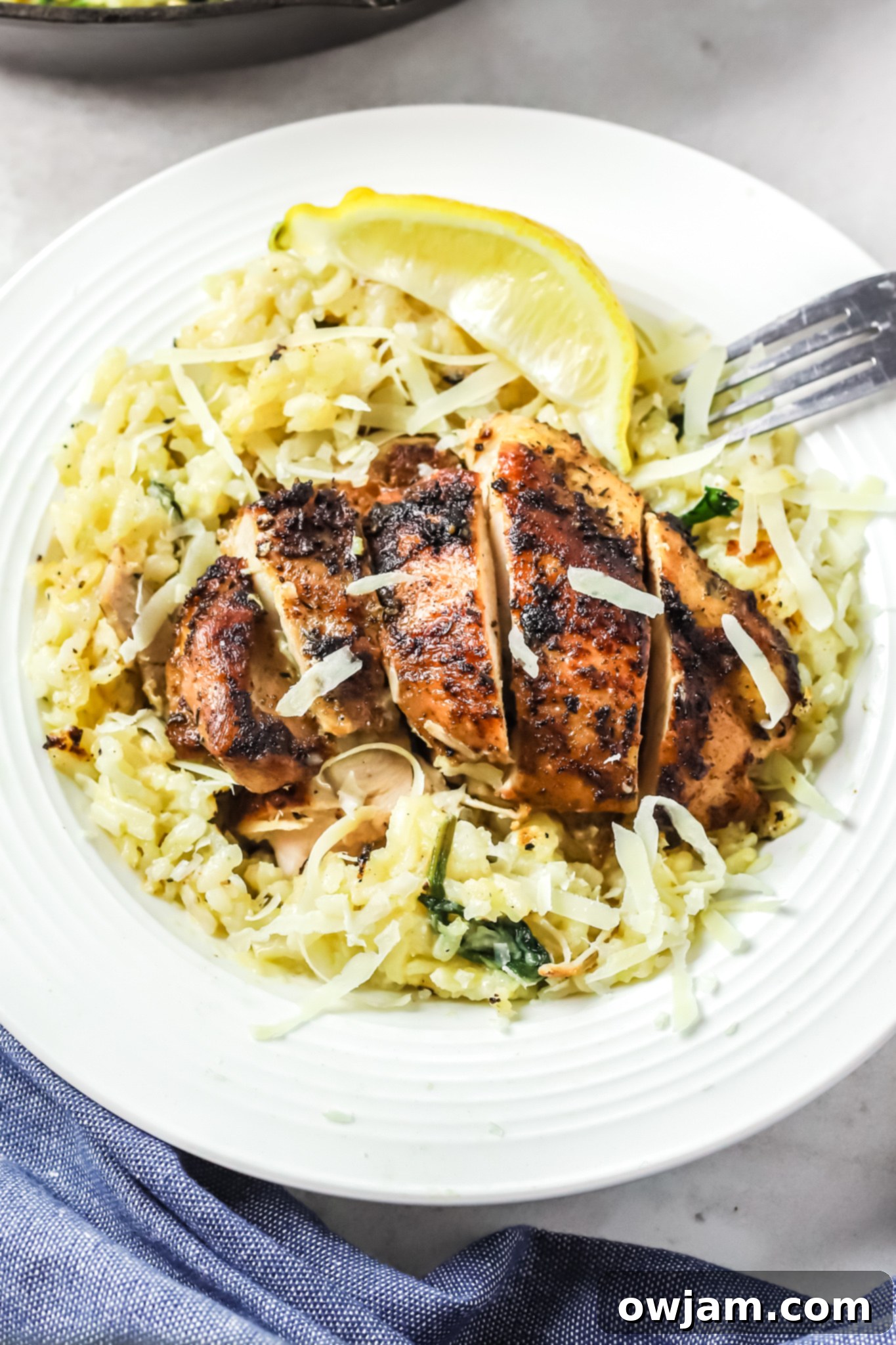 Oven Baked Chicken Thighs with Risotto with a fork. 