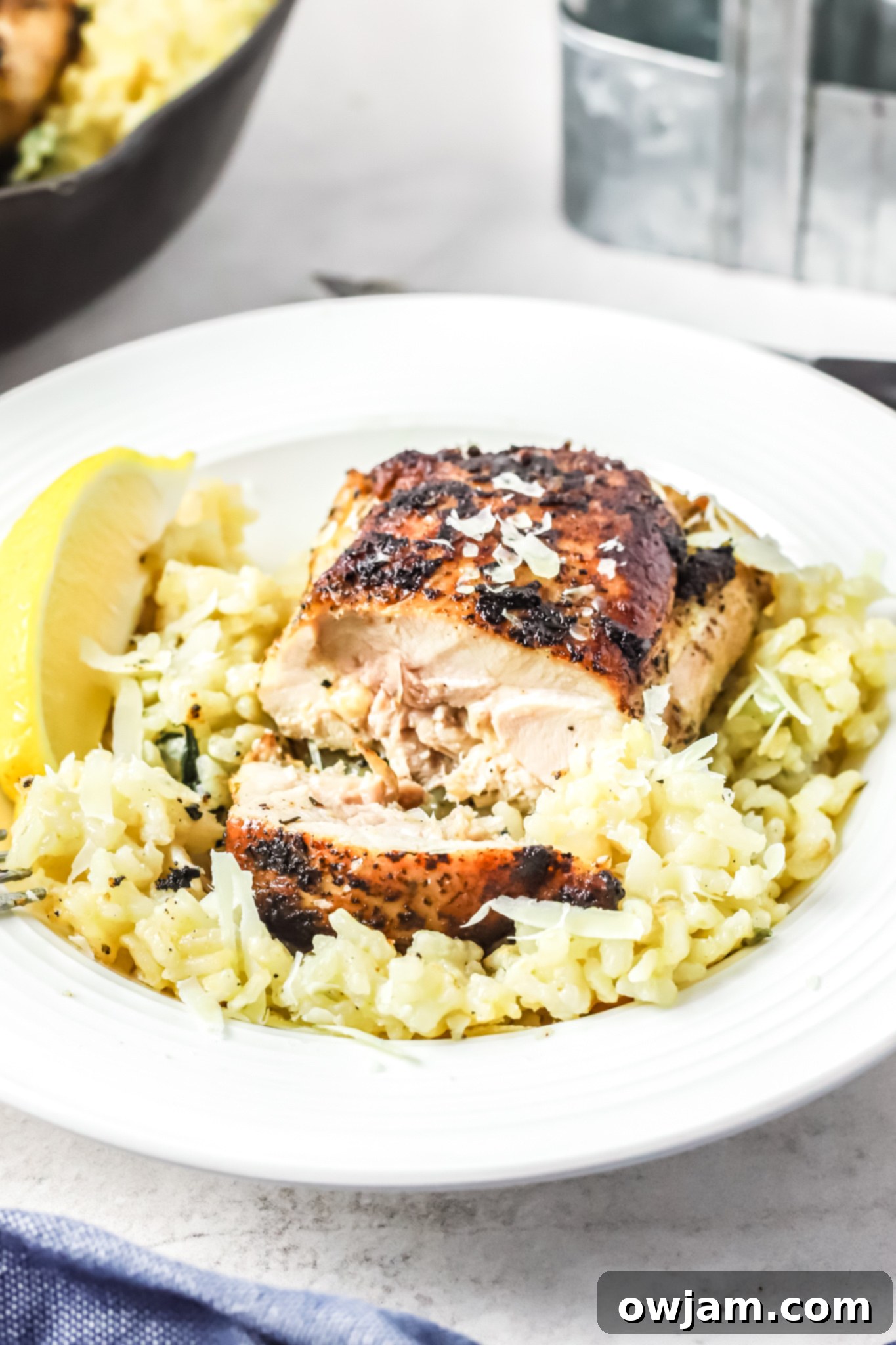 Oven Baked Chicken Thighs with Risotto on a white plate. 