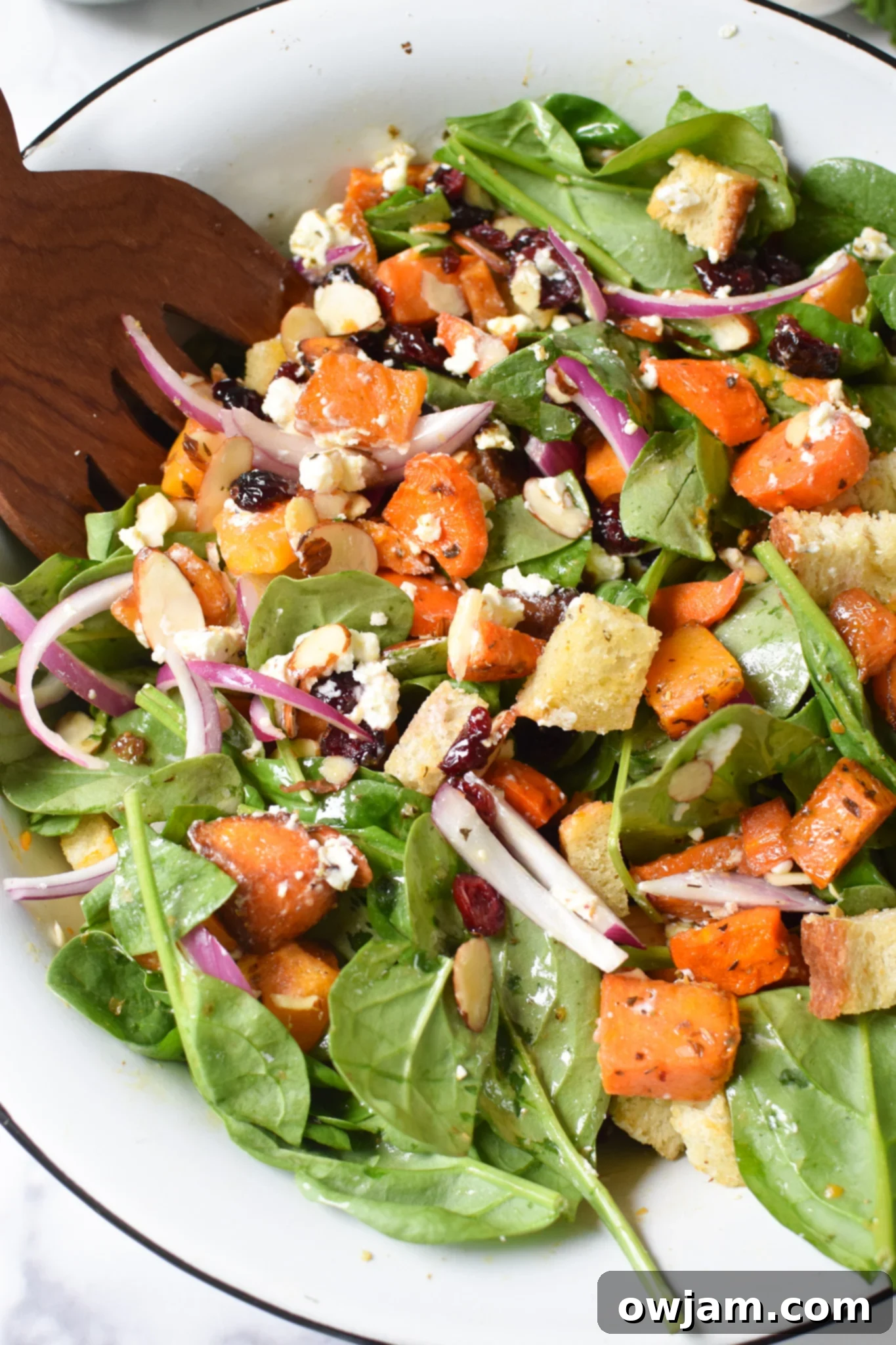 Roasted Vegetable Salad with wooden serving spoons.