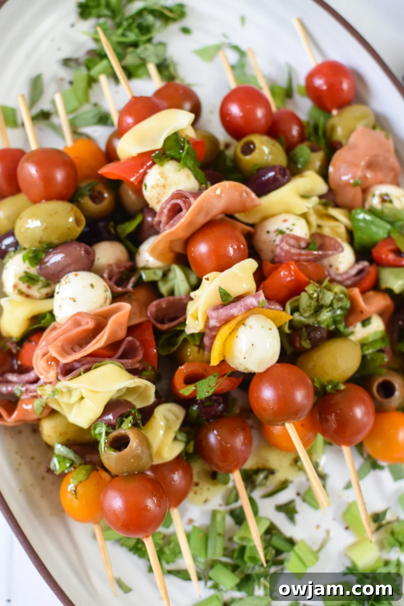 Italian Skewer Medley 2 Vibrant Antipasto Skewers arranged beautifully on a white platter, ready to be served as an appetizer.