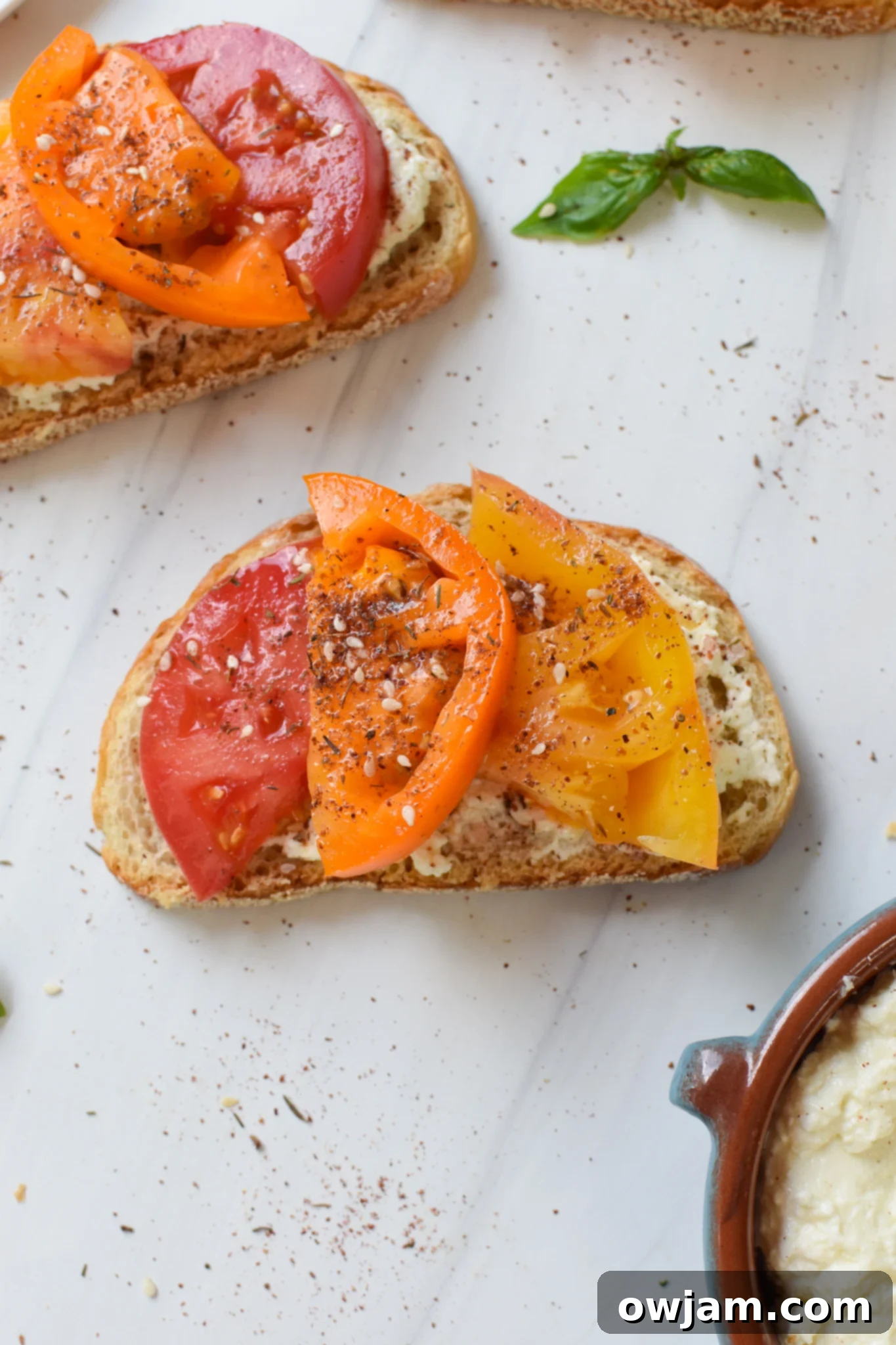 Creamy Feta Tomato Toast 2 Tomato Toast with Whipped Feta with fresh basil.