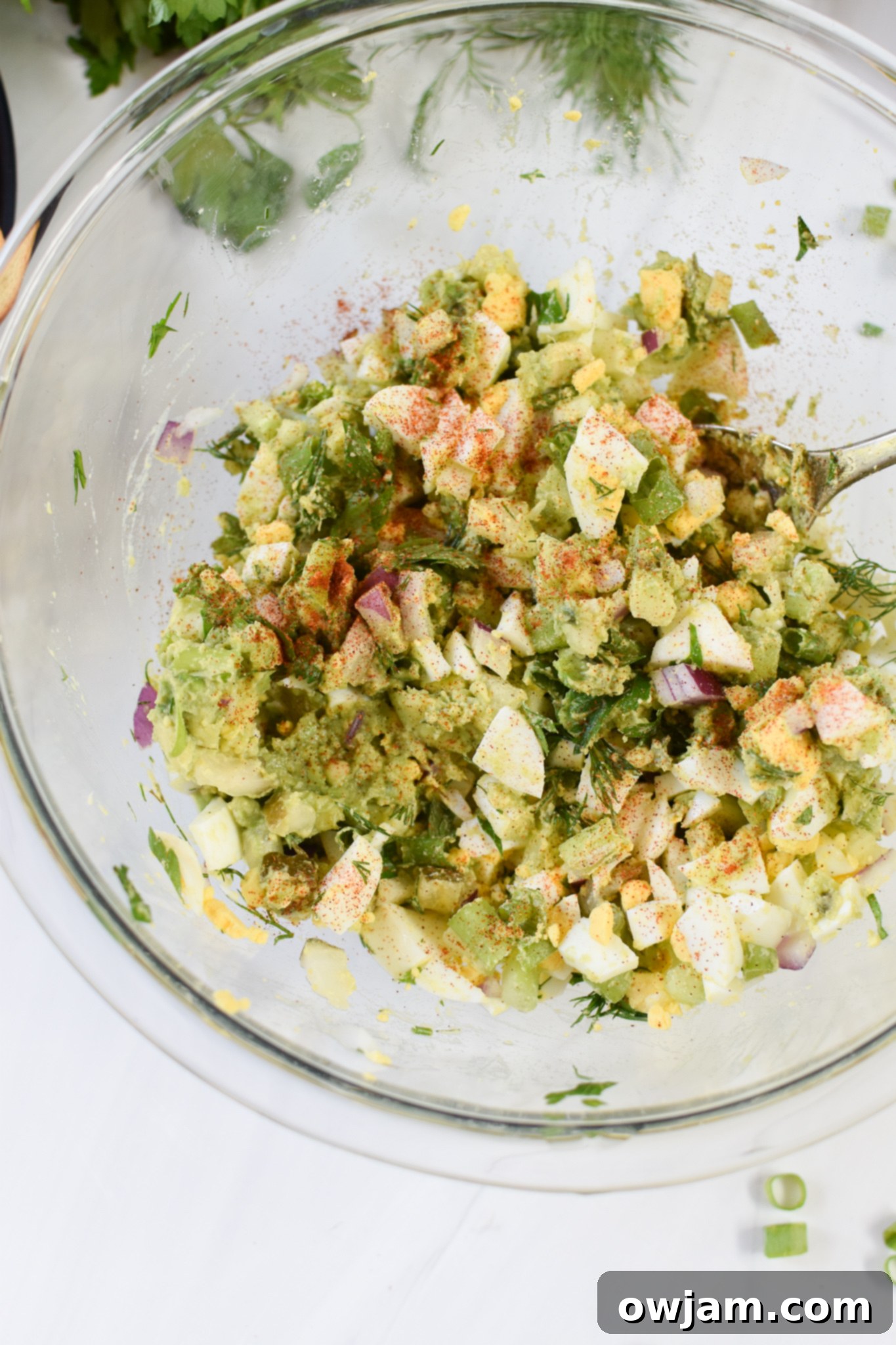 Creamy Avocado Egg Salad 8 Close-up of creamy Avocado Egg Salad, highlighting the chopped eggs and fresh herbs.