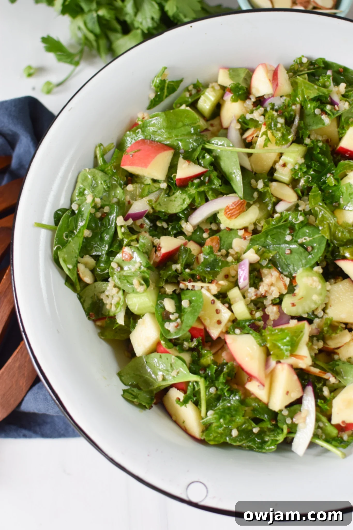 Nourishing Apple Kale Quinoa Salad 4 Apple Kale Quinoa Salad in a white bowl.