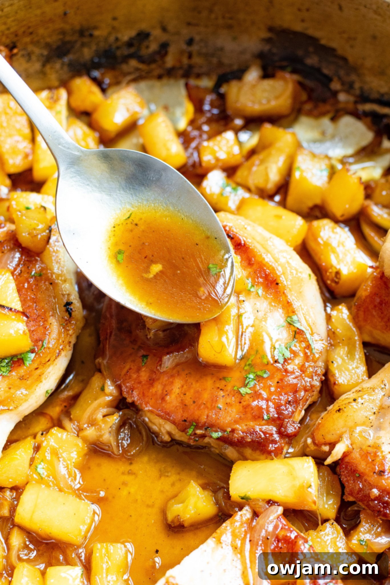 Sweet and Savory Pineapple Pork Chops 8 Easy Pineapple Pork Chops in a skillet, generously coated in the sweet and sour sauce with visible pineapple chunks.