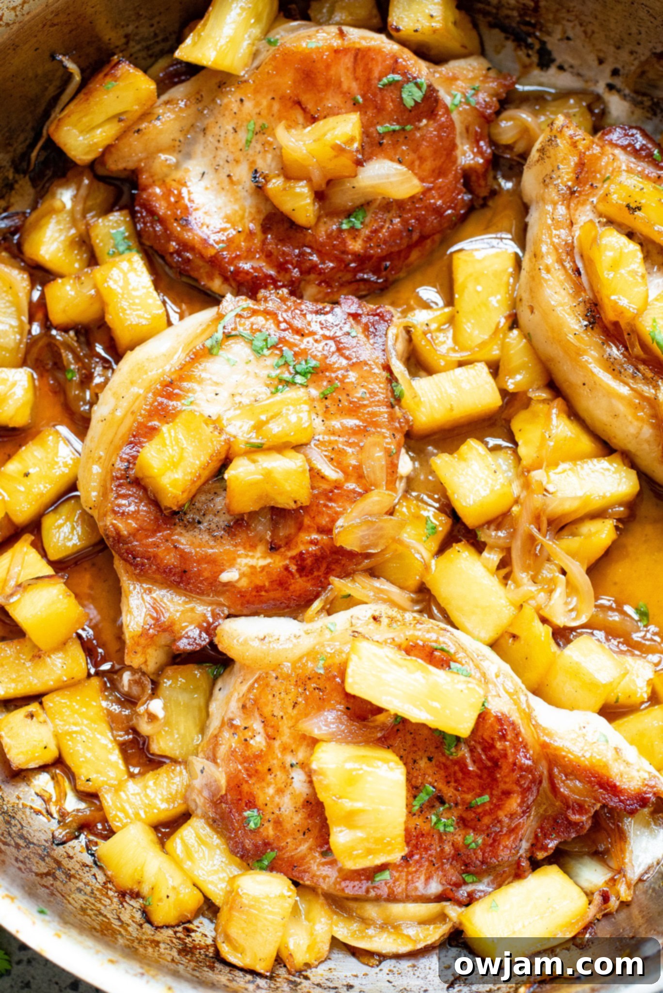 Sweet and Savory Pineapple Pork Chops 9 Close-up of Easy Pineapple Pork Chops with abundant pineapple chunks in a skillet, ready to serve.