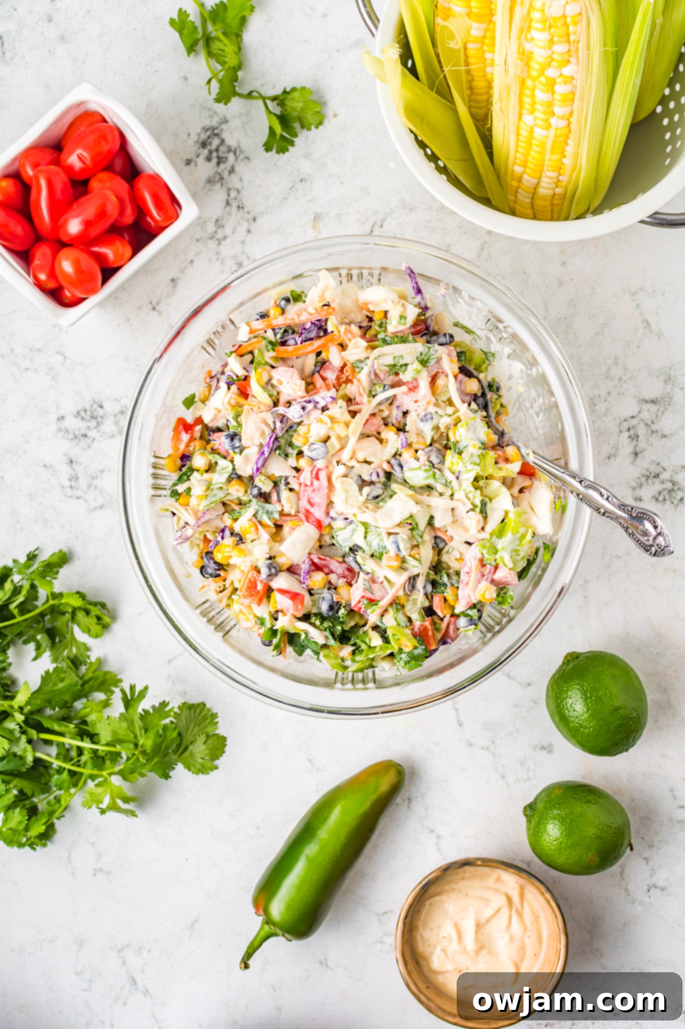Easy Mexican Coleslaw in a clear serving bowl, showing the texture and colors of the ingredients