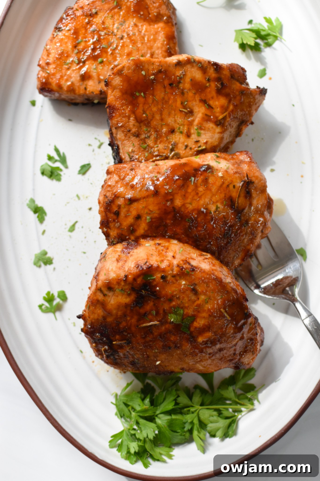 Air Fryer Boneless Pork Chops on a white plate. 