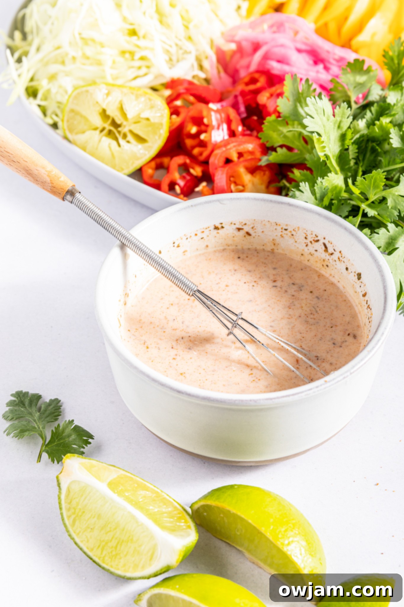 Easy Caribbean Coleslaw Recipe dressing in a small bowl.