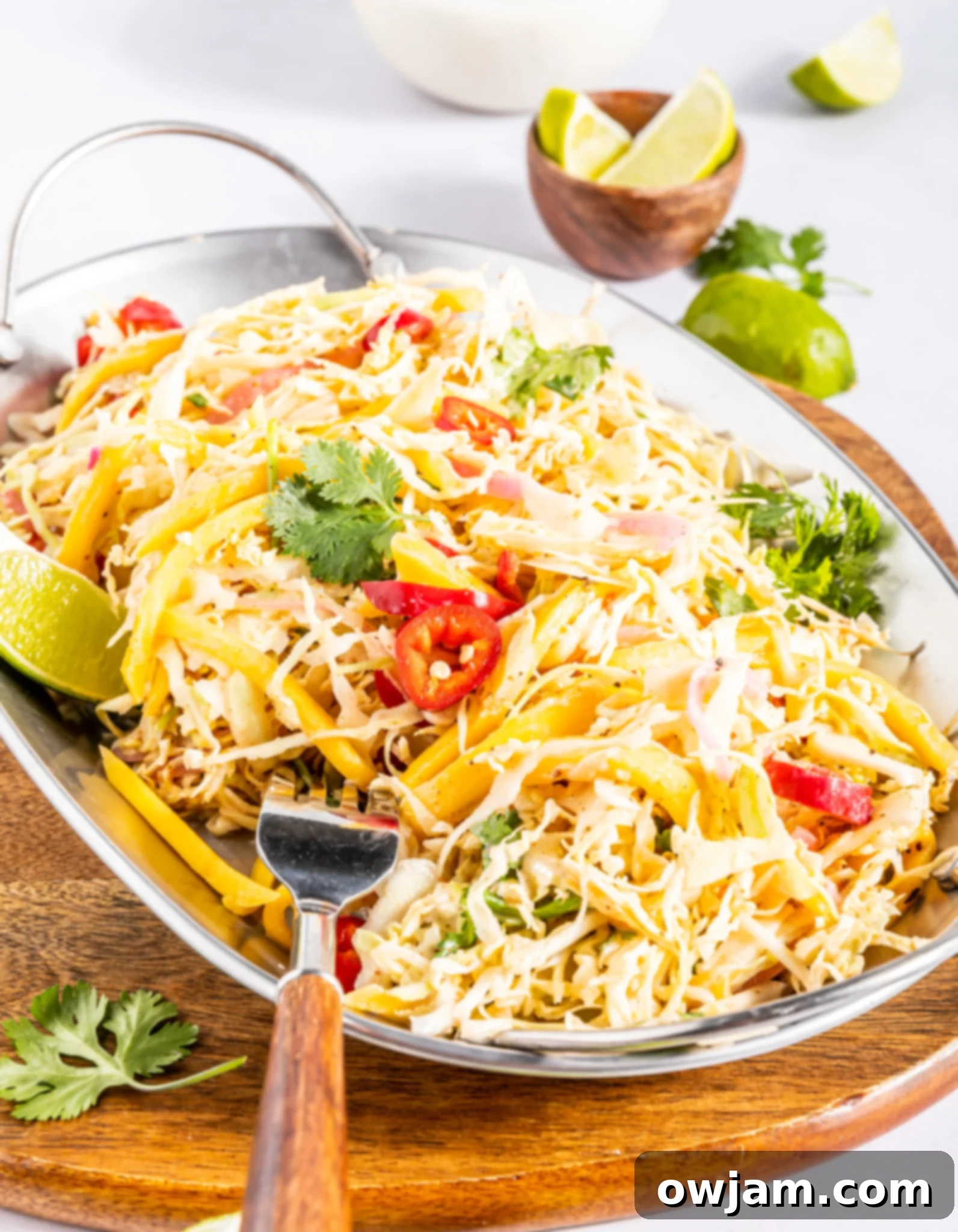 Easy Caribbean Coleslaw Recipe garnished with fresh cilantro in a serving bowl.