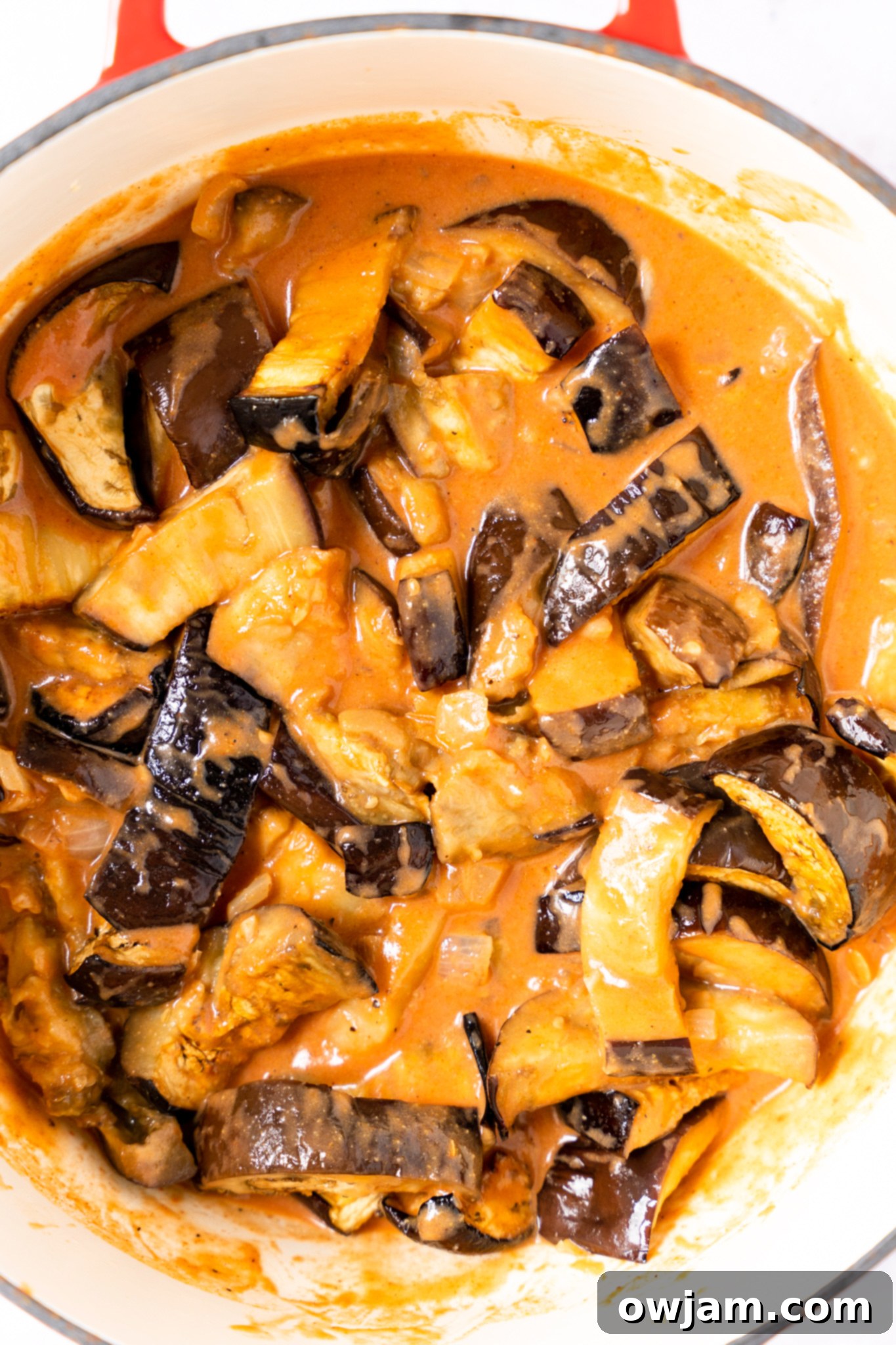 Easy Eggplant Curry simmering in a pot, showing the rich, creamy sauce with roasted eggplant pieces.
