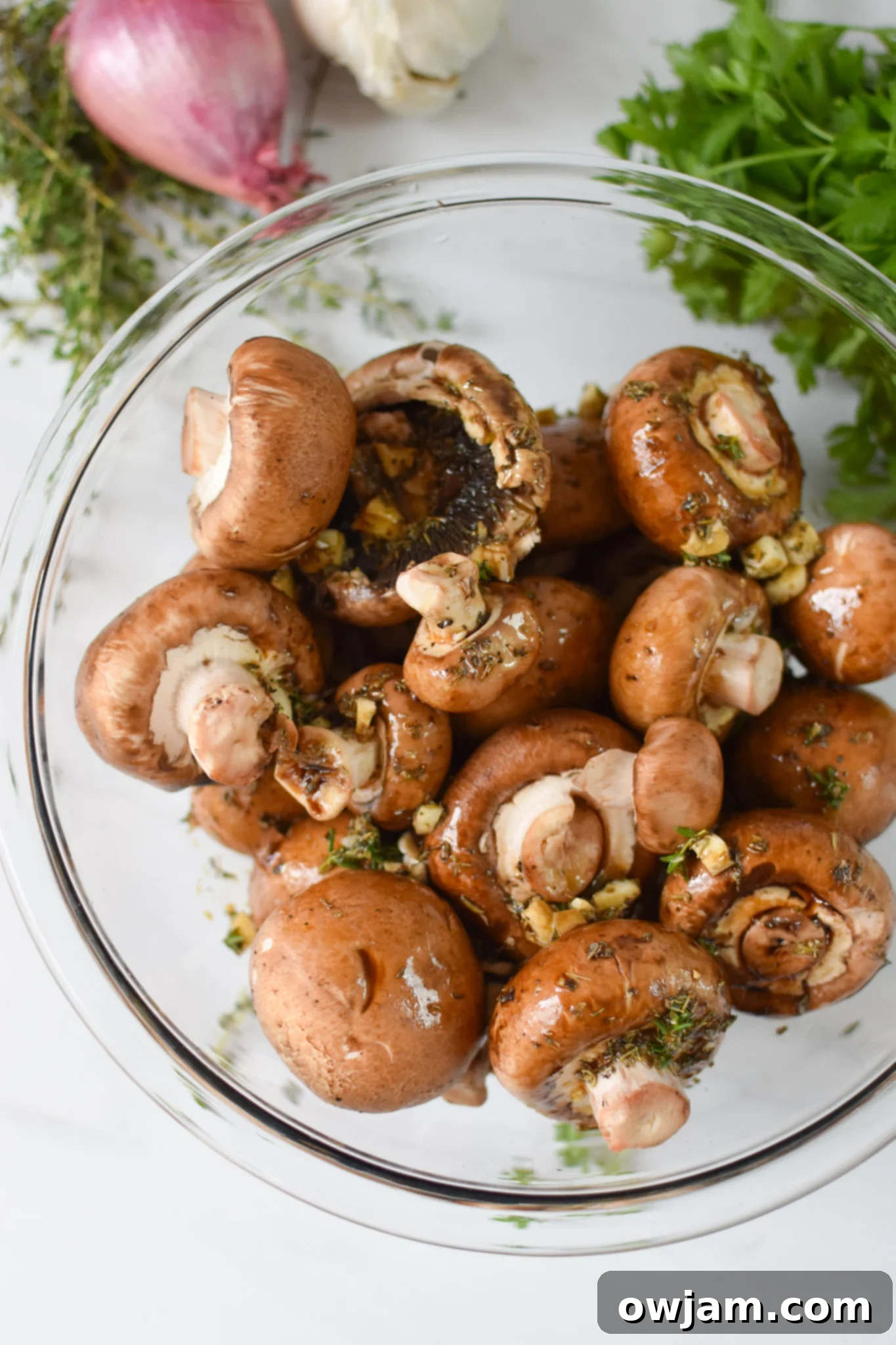 Flavorful Balsamic Roasted Mushrooms 3 Assortment of fresh ingredients for roasted balsamic mushrooms, including whole mushrooms, garlic, shallots, and herbs.