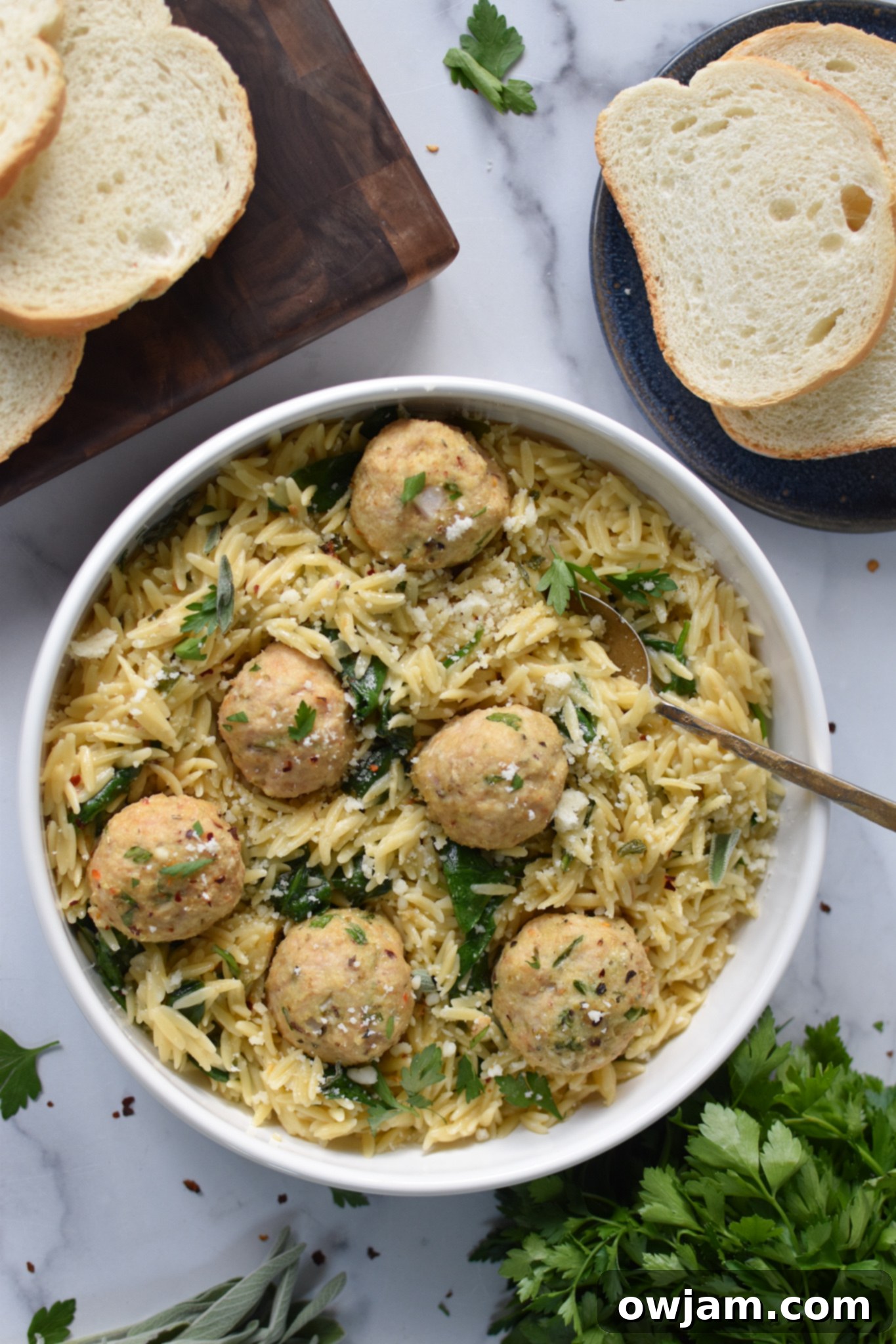 Golden Baked Chicken Bites 2 Baked Chicken Meatballs with a fork in a white bowl.