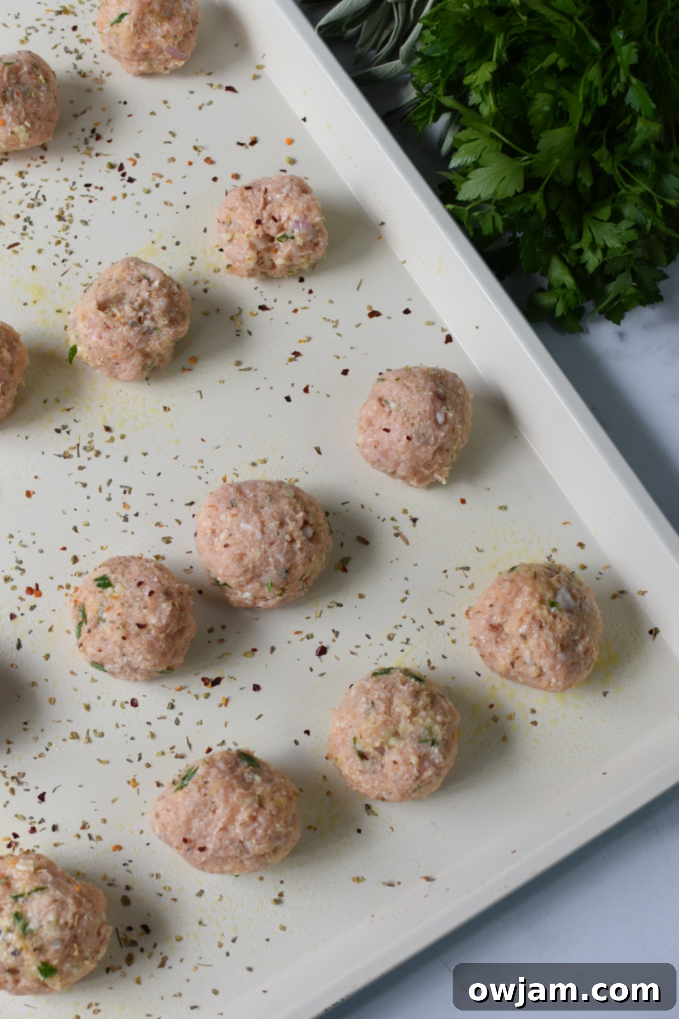 Golden Baked Chicken Bites 6 Baked Chicken Meatballs on a baking sheet.