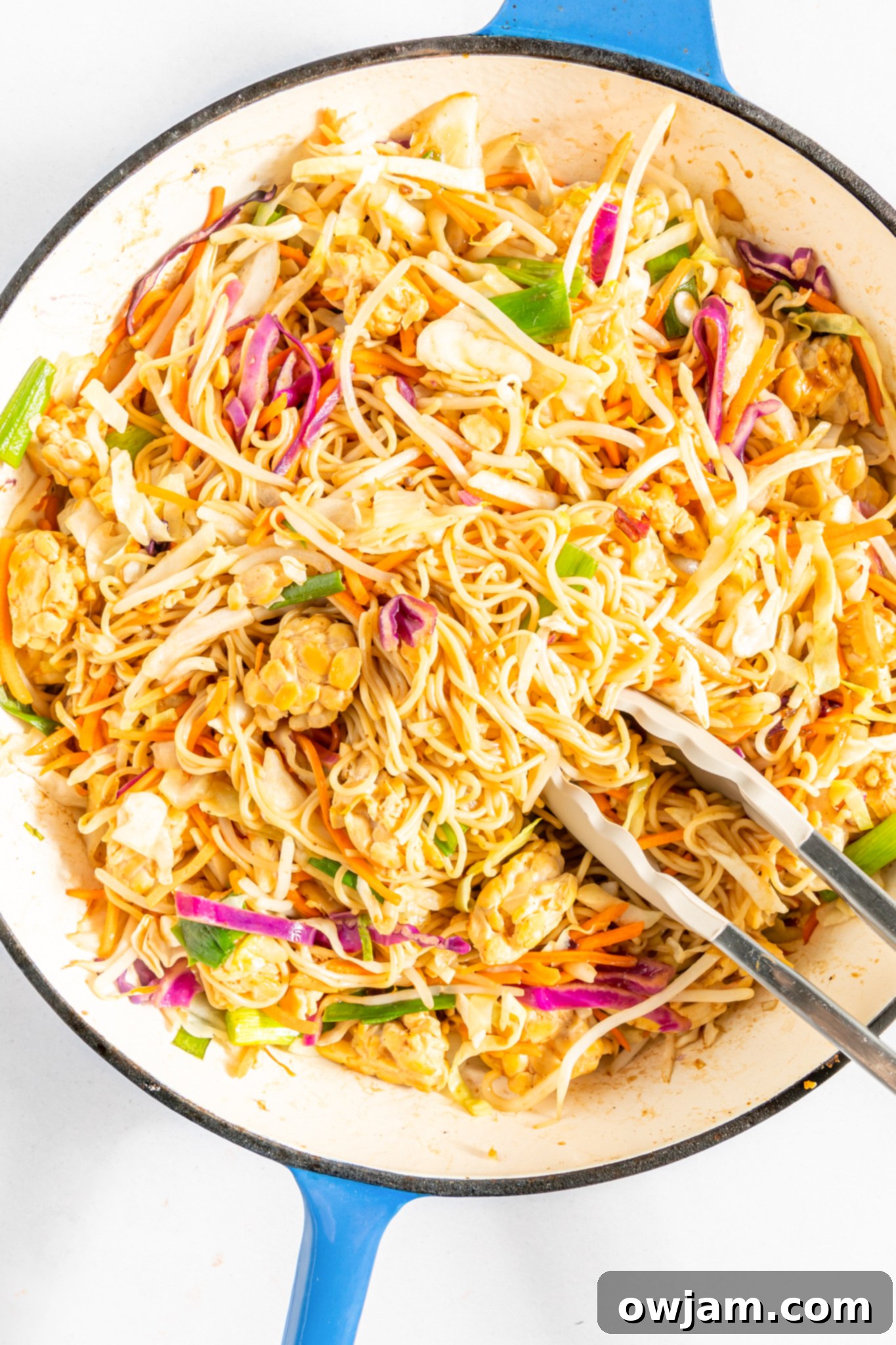 Quick Veggie Chow Mein 7 Easy Vegetable Chow Mein being served with tongs from a large skillet.