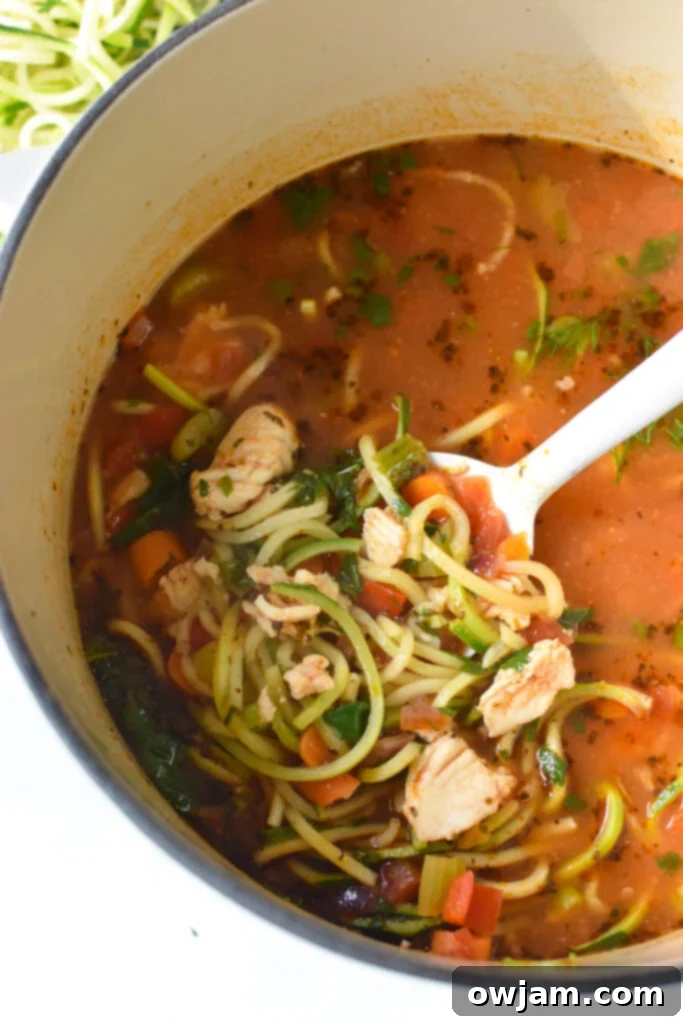 Hearty Mediterranean Fish Soup simmering in a Dutch oven, ready to be served.