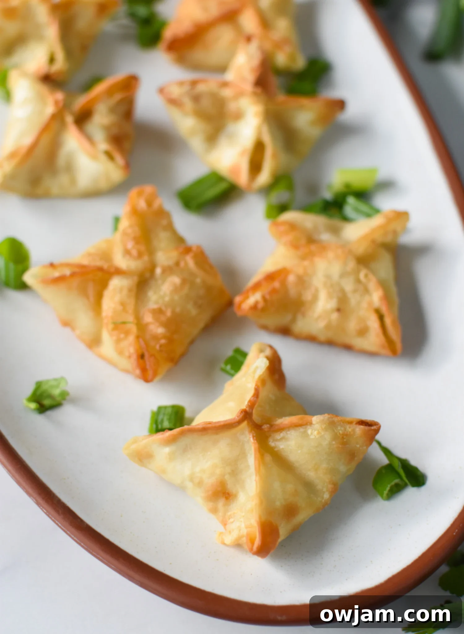 Crispy Air Fryer Crab Rangoon 2 A platter of golden-brown Air Fryer Crab Rangoon, perfect for an easy homemade appetizer.