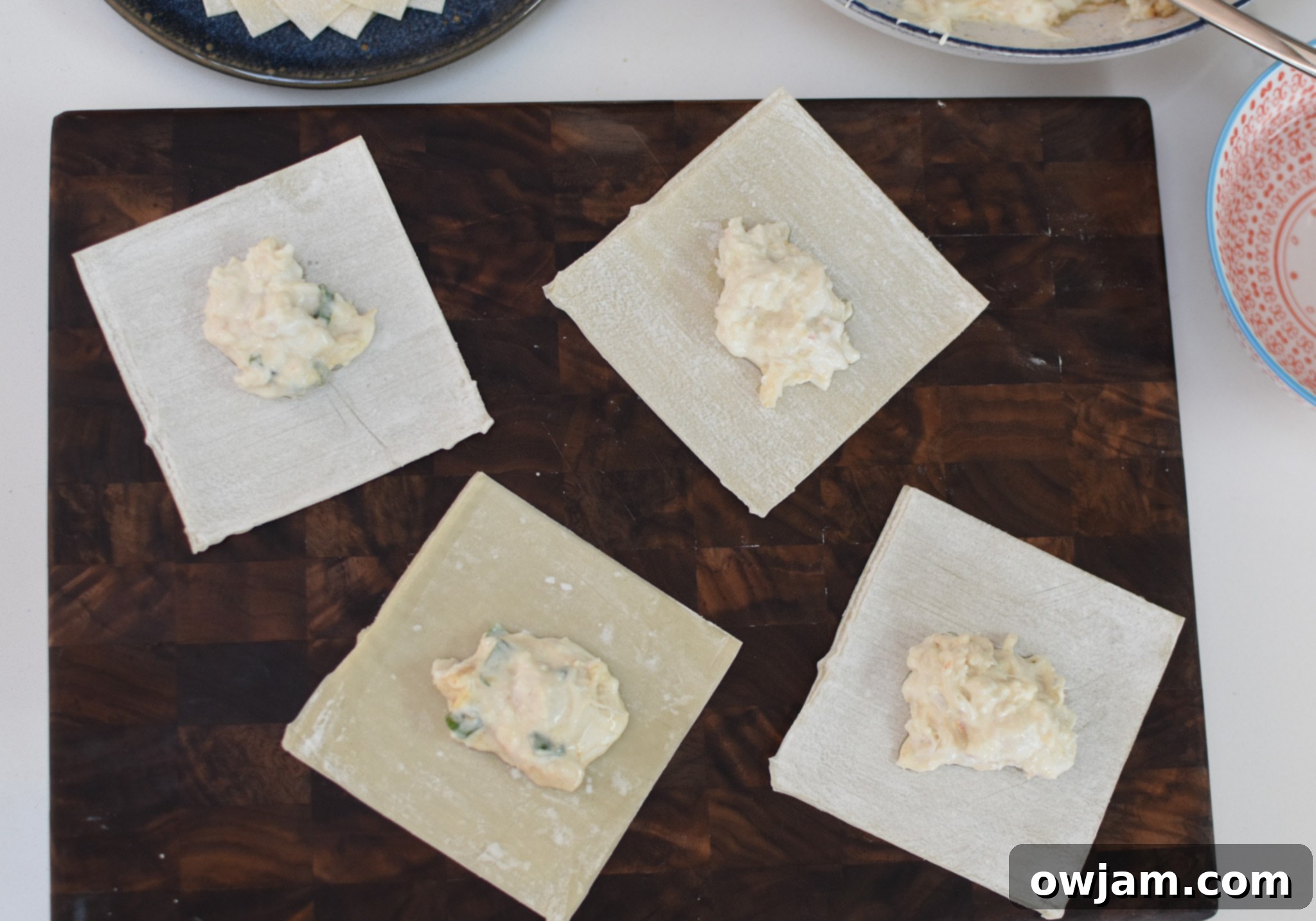 Crispy Air Fryer Crab Rangoon 6 A single wonton wrapper with a spoonful of crab and cream cheese mixture placed in its center, ready for folding into Air Fryer Crab Rangoon.