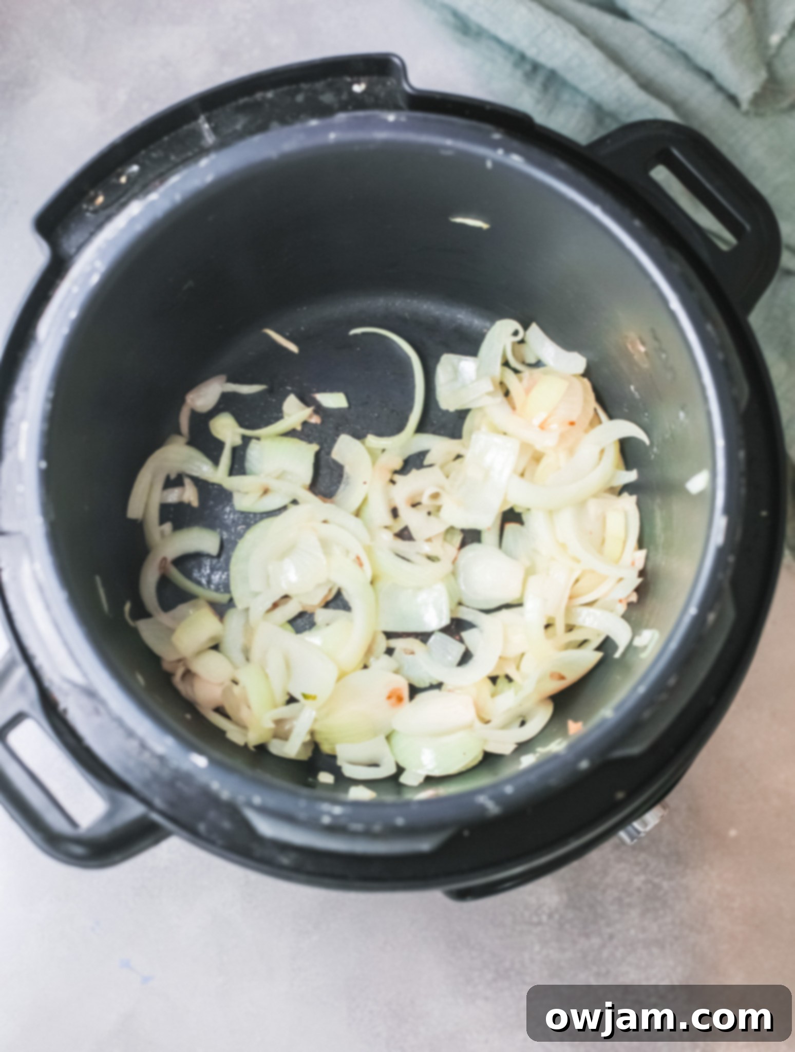 Creamy Instant Pot Broccoli Soup 5 Onions sautéing in an Instant Pot, a crucial first step for the broccoli soup.
