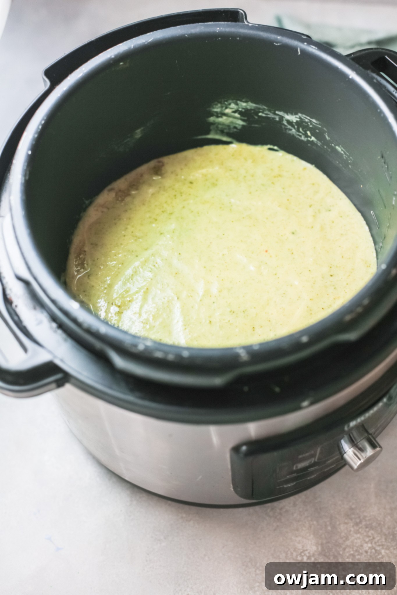 Creamy Instant Pot Broccoli Soup 7 Creamy Instant Pot Broccoli Soup being pureed with an immersion blender.