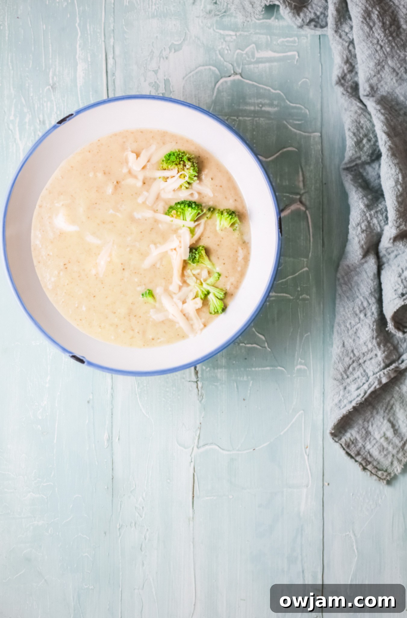 Creamy Instant Pot Broccoli Soup 8 Creamy Instant Pot Broccoli Soup with melted cheese being stirred in.