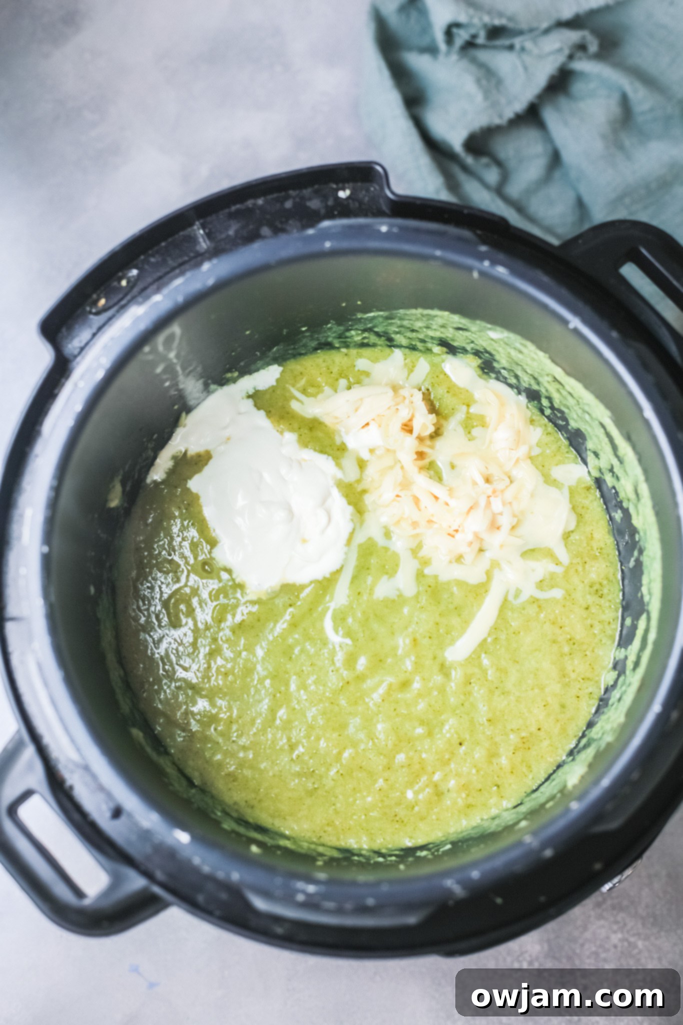 Creamy Instant Pot Broccoli Soup 9 Instant Pot Broccoli Soup with a swirl of cream on top, ready to be served.
