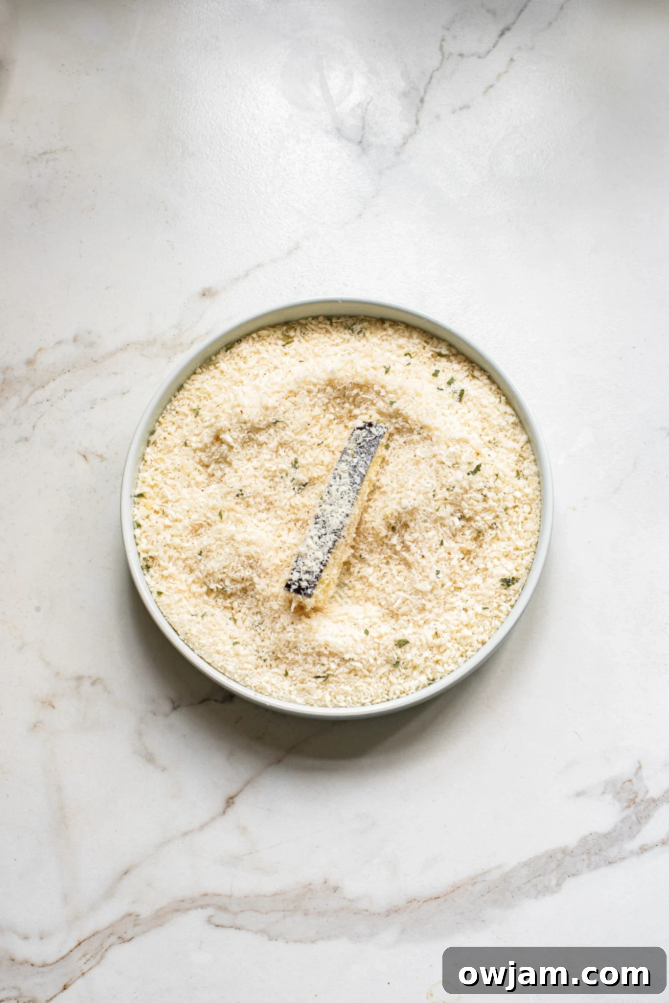 Crispy Air Fryer Eggplant Fries 7 Eggplant sticks fully coated in a flavorful panko breadcrumb mixture, ready for the air fryer.