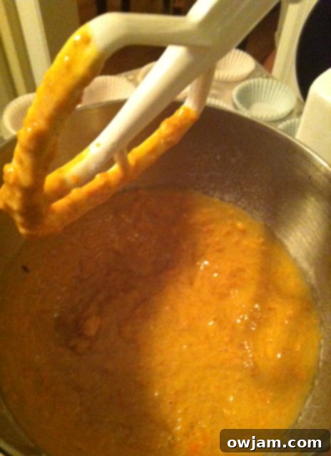 Carrot cupcake batter in a bowl, showing the consistency and shredded carrots, ready to be scooped