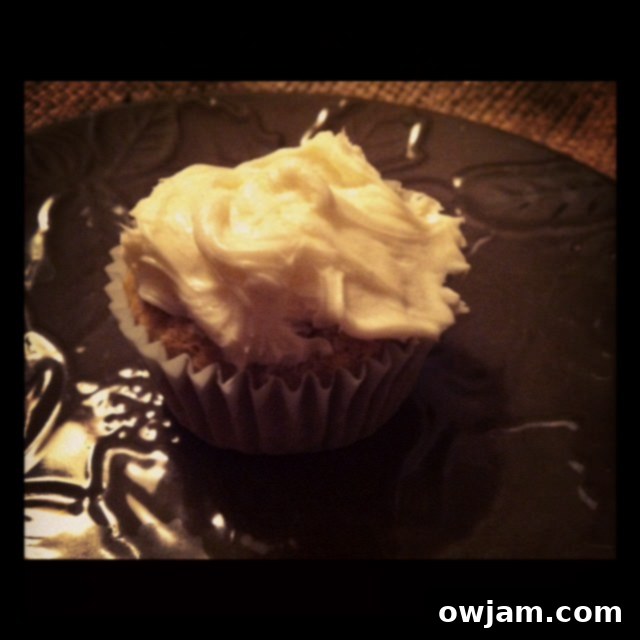 A perfectly frosted homemade carrot cupcake, topped with creamy icing and ready to be enjoyed
