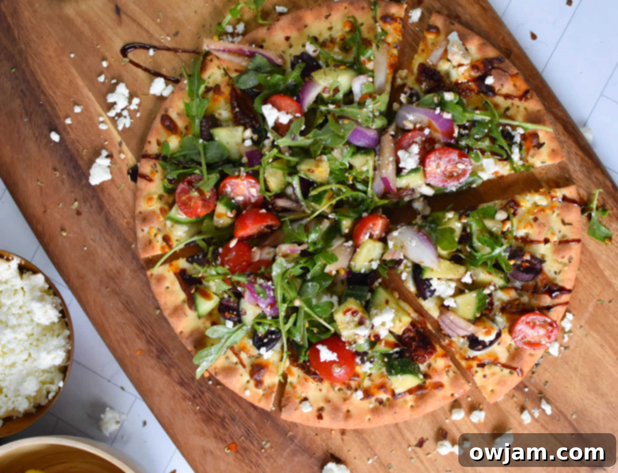 Greek Pizza on a cutting board