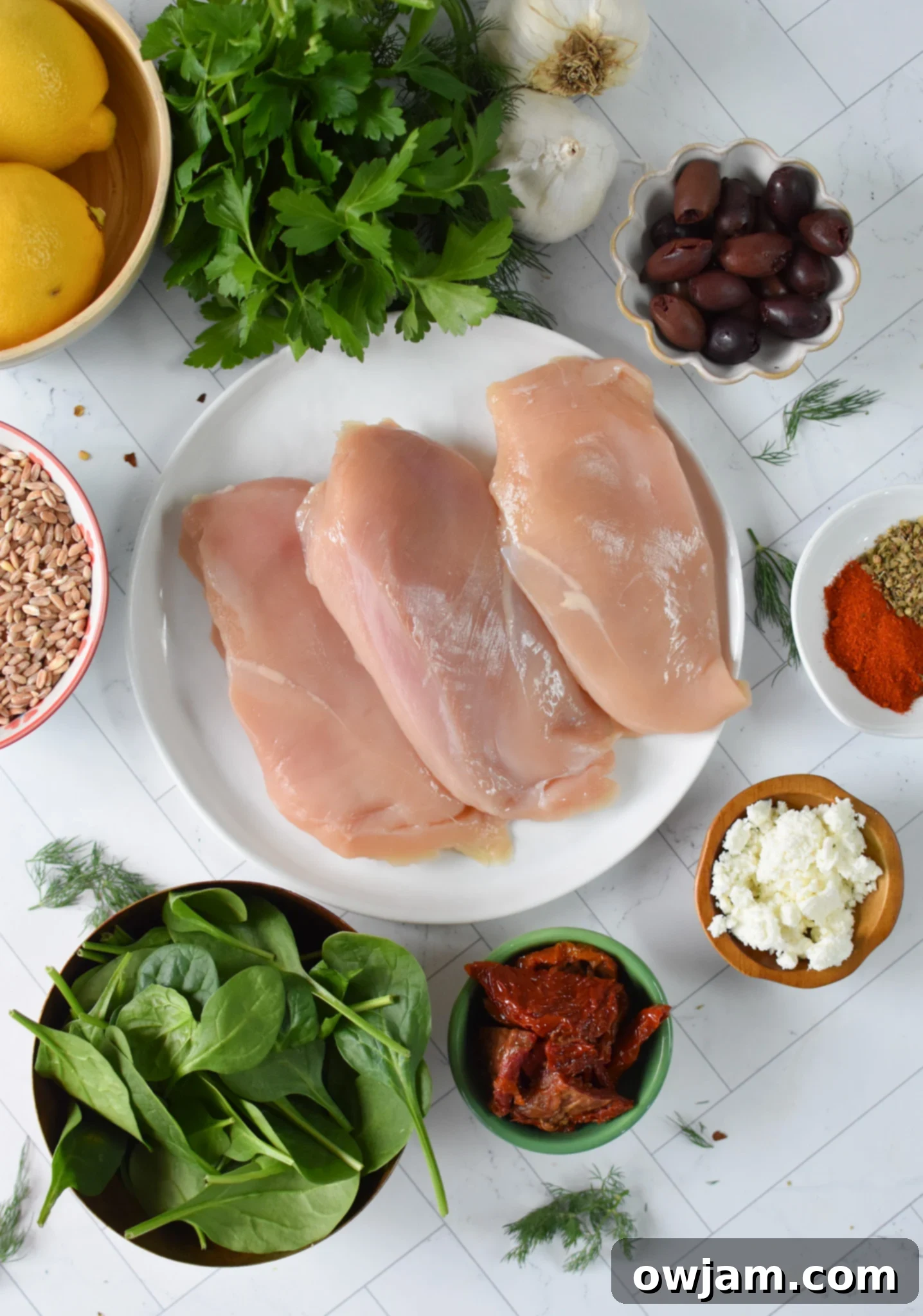 Mediterranean Sun-dried Tomato Chicken Farro Bake 3 Assorted ingredients for Sun-dried Tomato Farro Chicken Bake, including chicken, farro, sun-dried tomatoes, and spices.