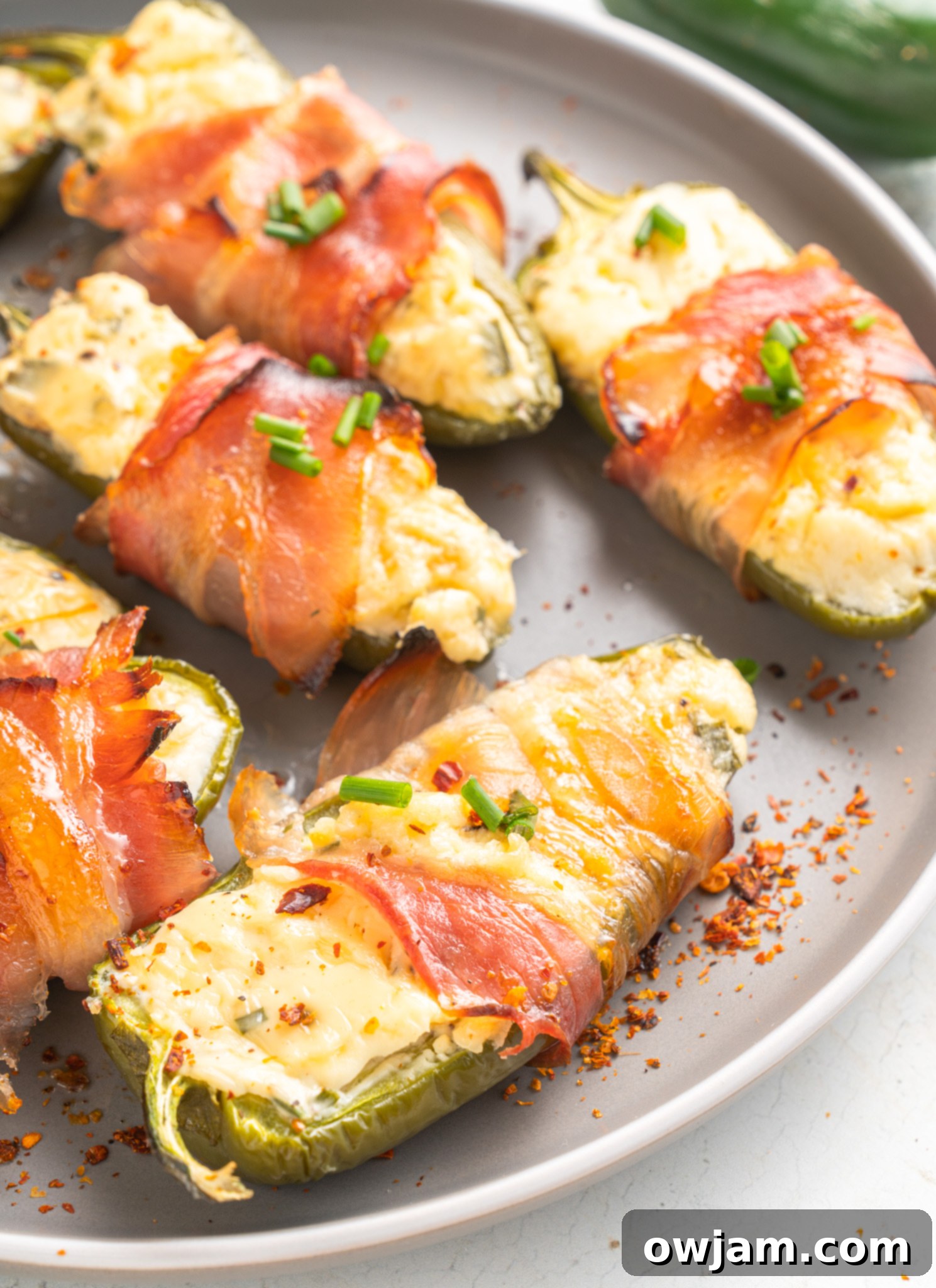 Jalapeño Poppers with Bacon on a round plate. 