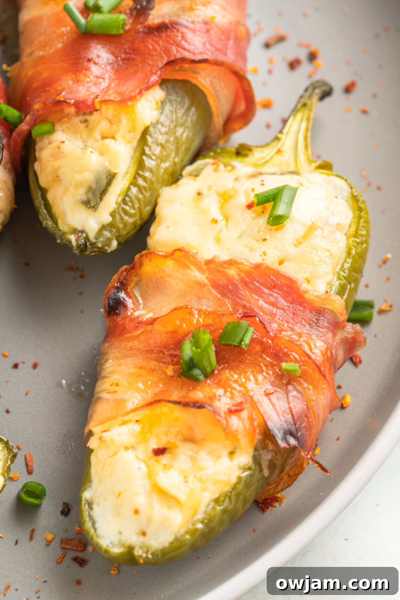 Jalapeño Poppers with Bacon popper along on a round plate. 