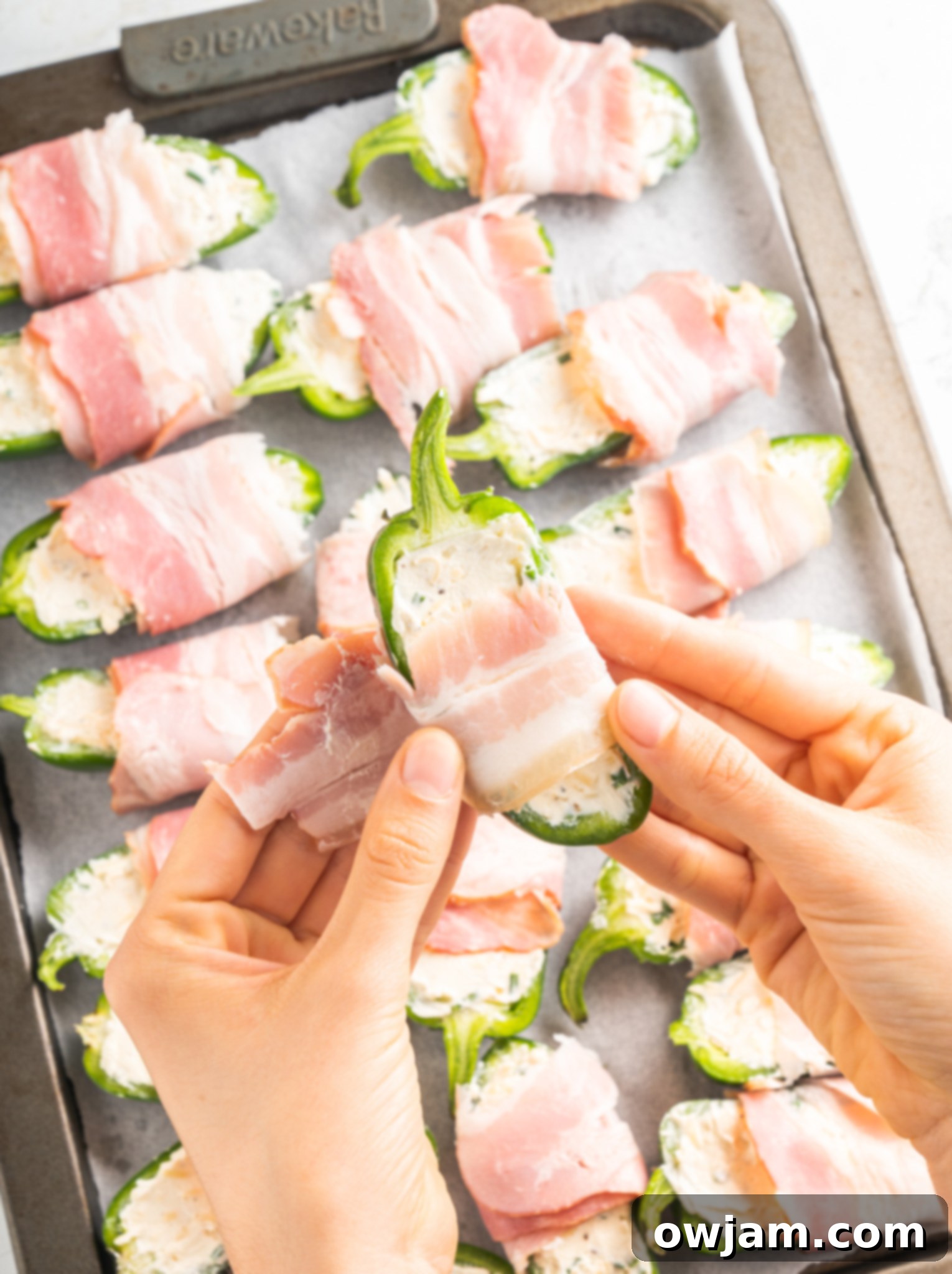 Jalapeño Poppers with Bacon wrapping bacon.