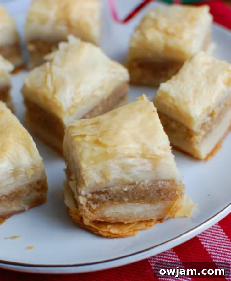 Unlock the Secrets of Perfect Baklava 3 Close-up of baklava layers with a golden brown, crispy top, showcasing the intricate nut filling and perfectly buttered phyllo layers beneath.
