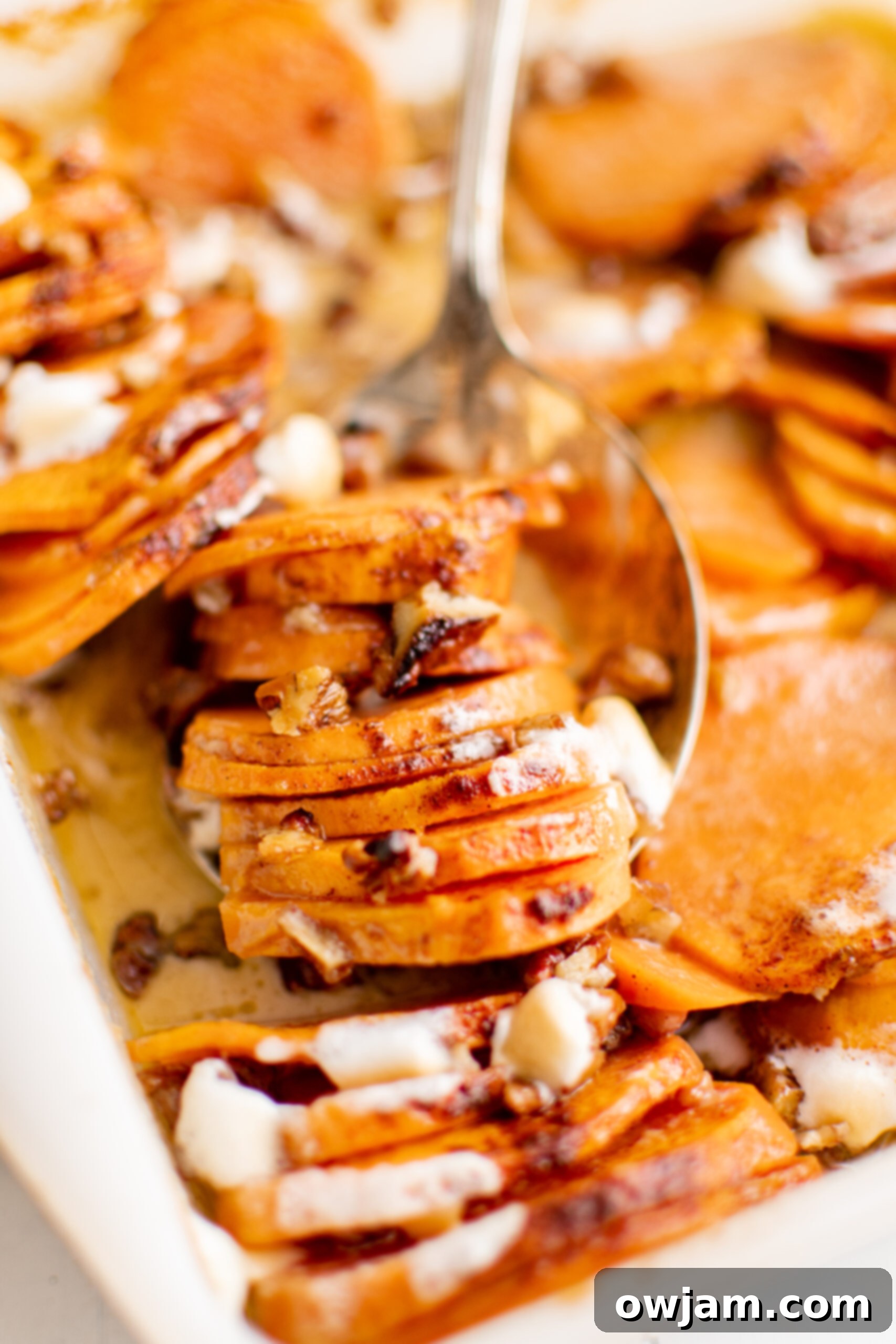 Effortless Sweet Potato Bake 9 Easy Scalloped Sweet Potatoes with spoon.