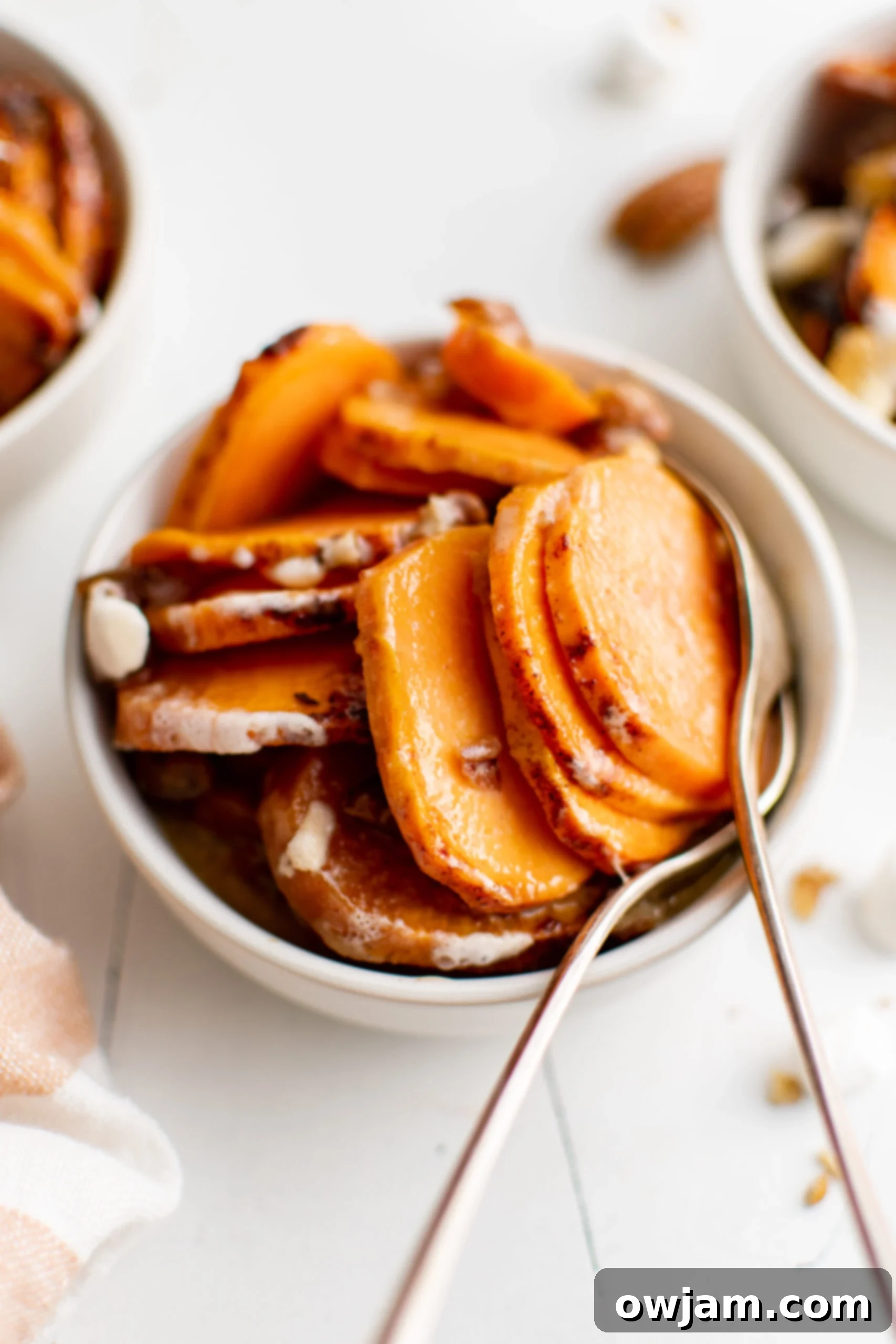 Effortless Sweet Potato Bake 10 Easy Scalloped Sweet Potatoes with spoons.