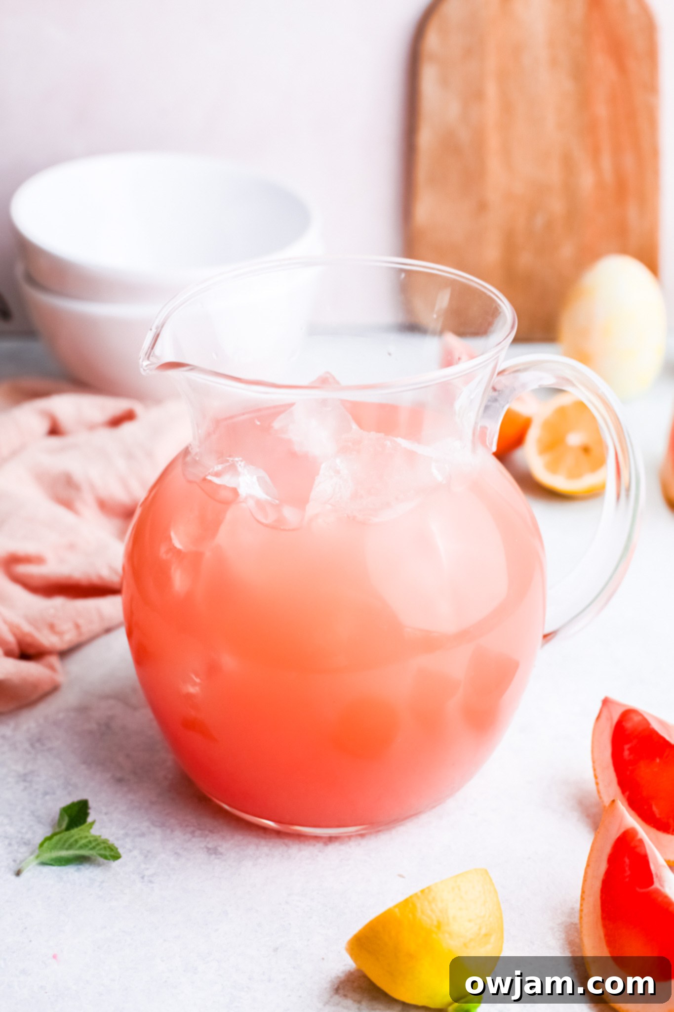 Tangy Grapefruit Paloma 4 Grapefruit Paloma Cocktail mixture in a pitcher with ice, ready to be poured.