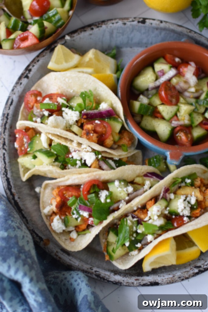 Mediterranean Garden Tofu Tacos 4 Mediterranean Style Tofu Tacos on a grey plate.