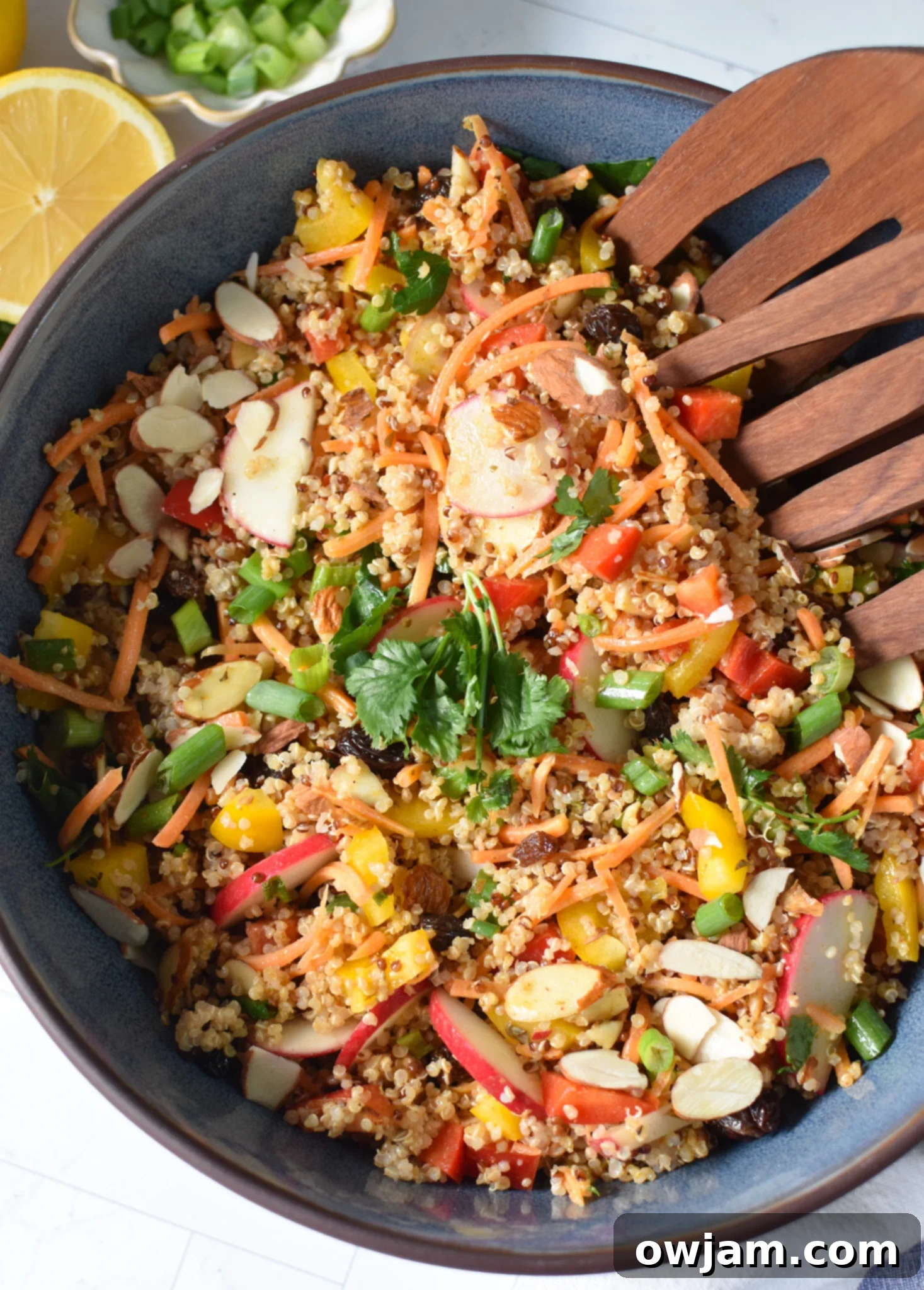 A serving of Curried Quinoa Salad in a stylish blue bowl, ready to be enjoyed.