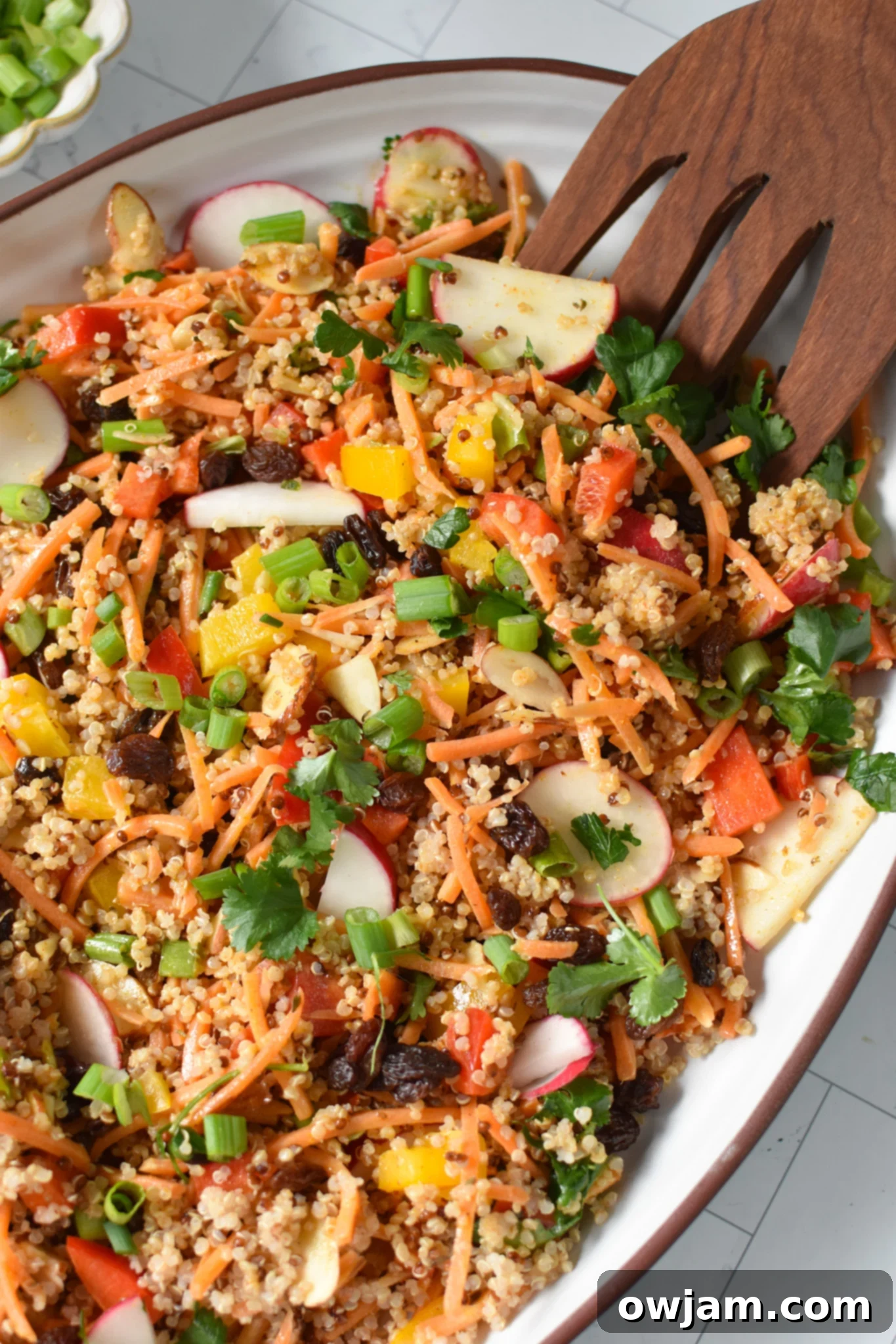 A generously portioned Curried Quinoa Salad displayed on a elegant white platter, perfect for serving guests.